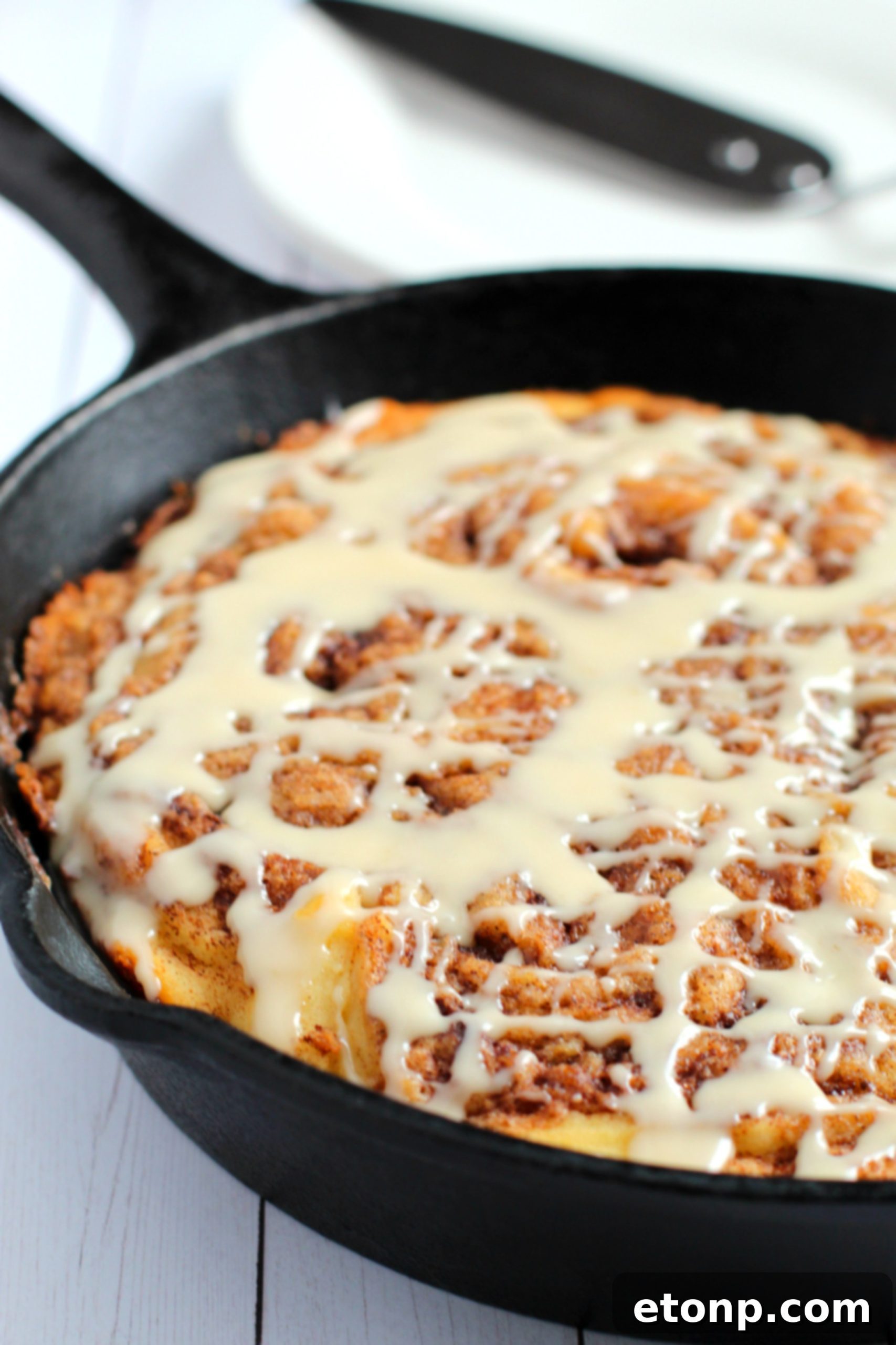 Warm Cinnamon Swirl Skillet Delight 2 Delicious Gluten-Free Cinnamon Roll Skillet Cake, freshly baked with a warm golden crust.