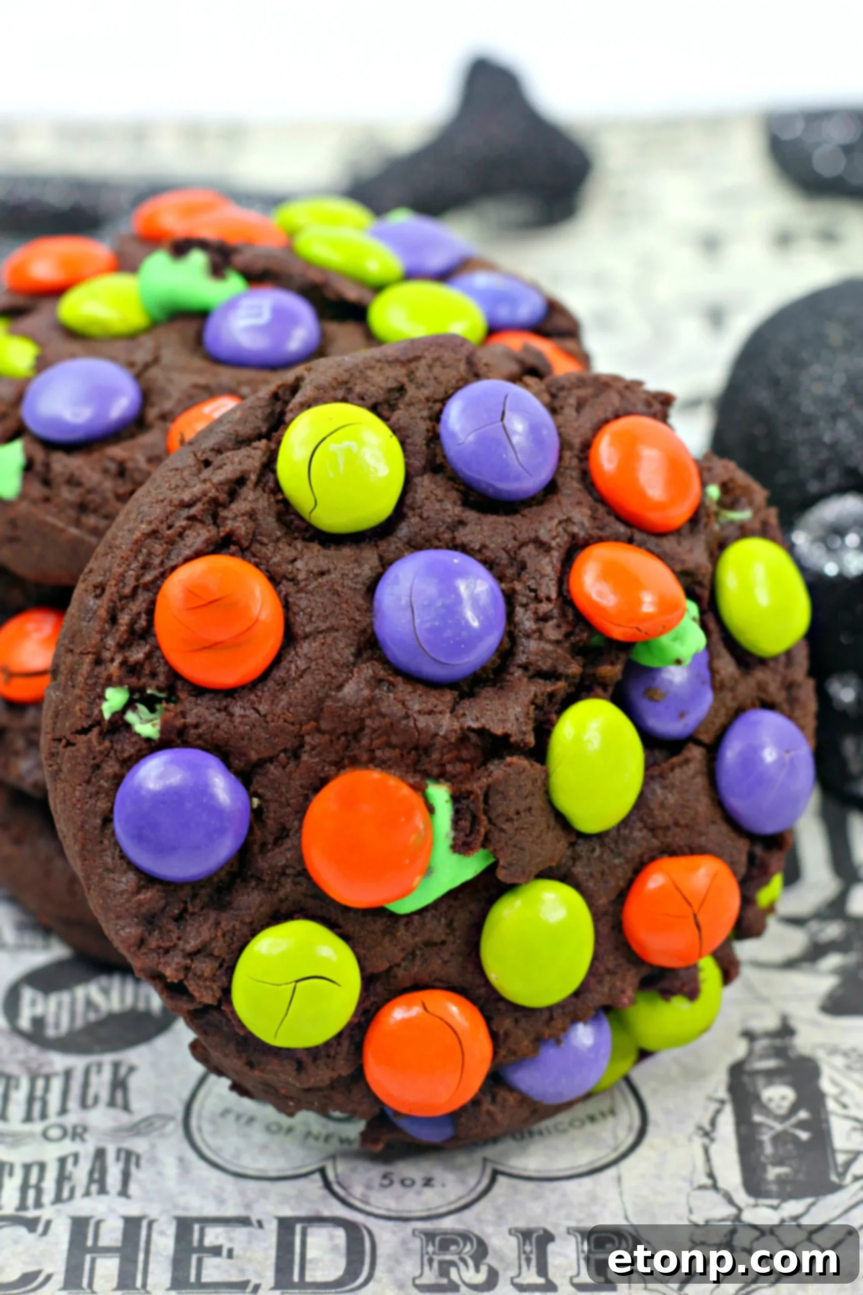 Close-up of freshly baked Monster Mash Chocolate Cookies with green, orange, and purple M&Ms