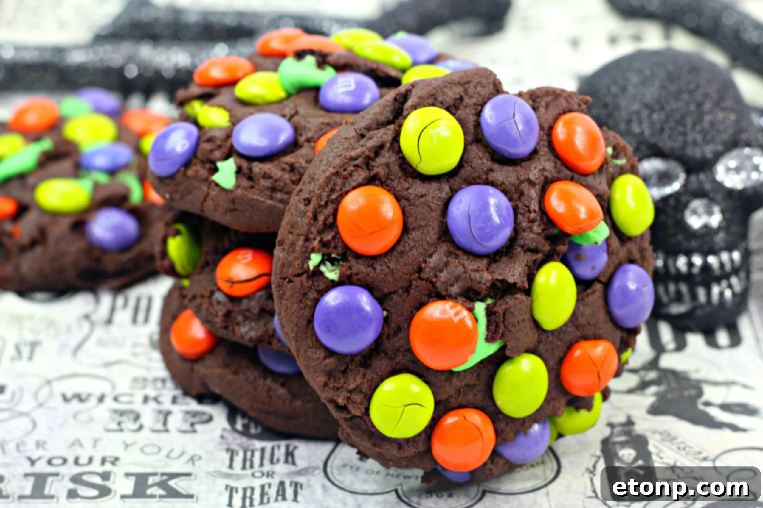Several Monster Mash Chocolate Cookies arranged on a cooling rack, showcasing their uniform size and vibrant colors.