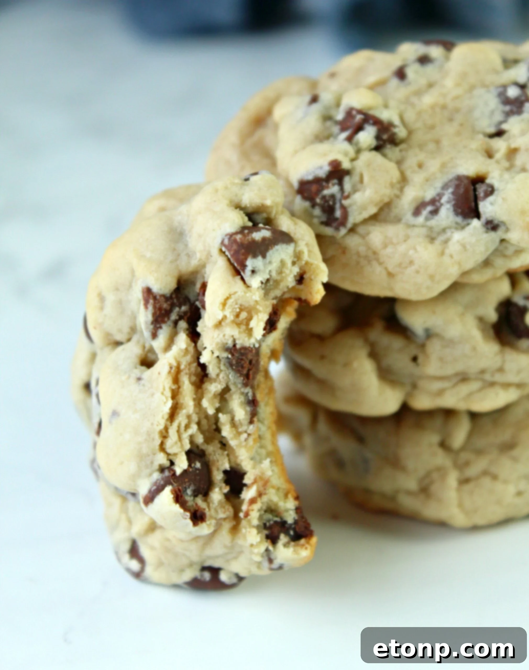 Creamy Dream Chocolate Chip Cookies 6 Raw cookie dough scooped onto parchment paper, perfectly shaped and ready for chilling to enhance flavor and texture.
