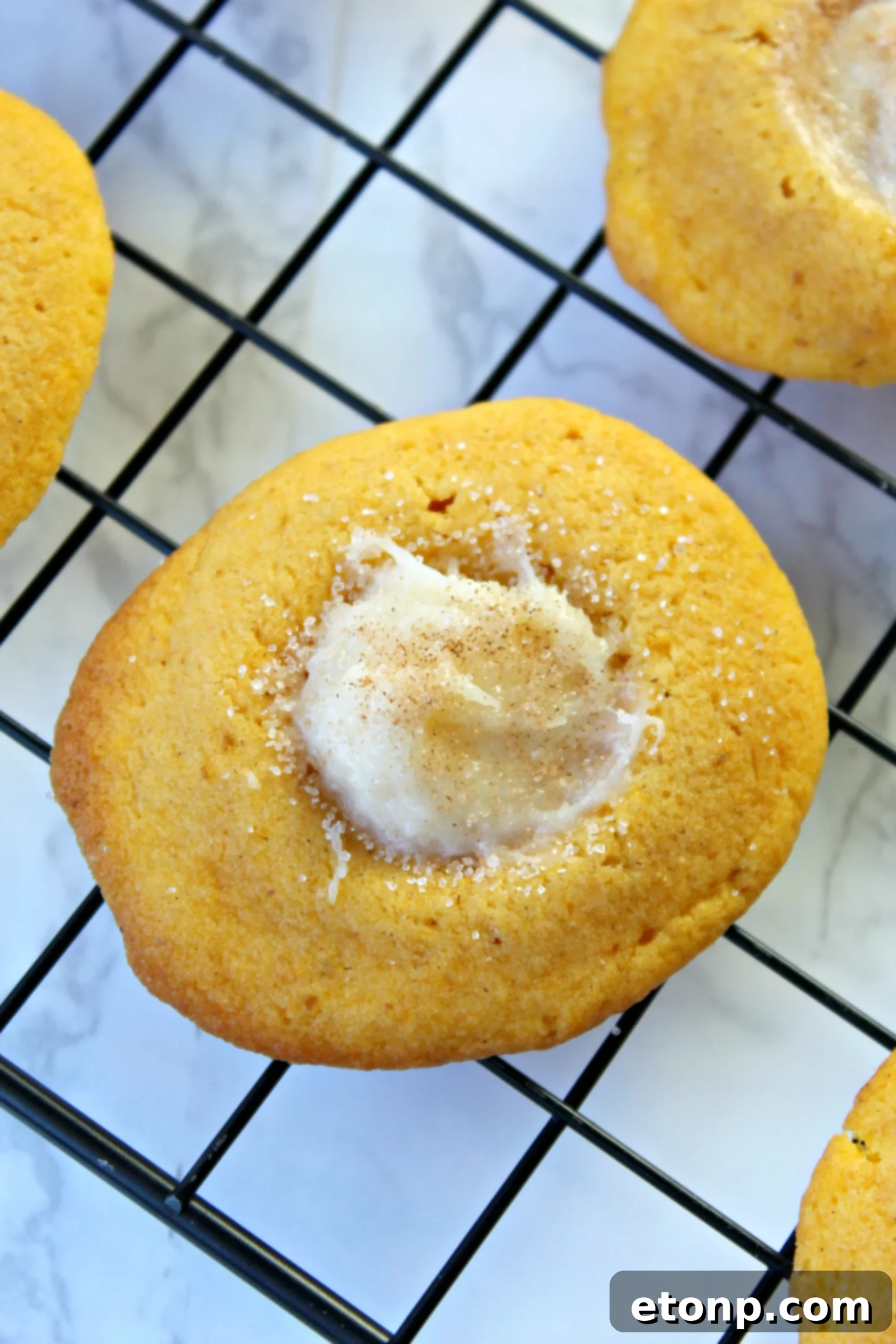 A tray of freshly baked pumpkin cheesecake thumbprint cookies, ready for serving