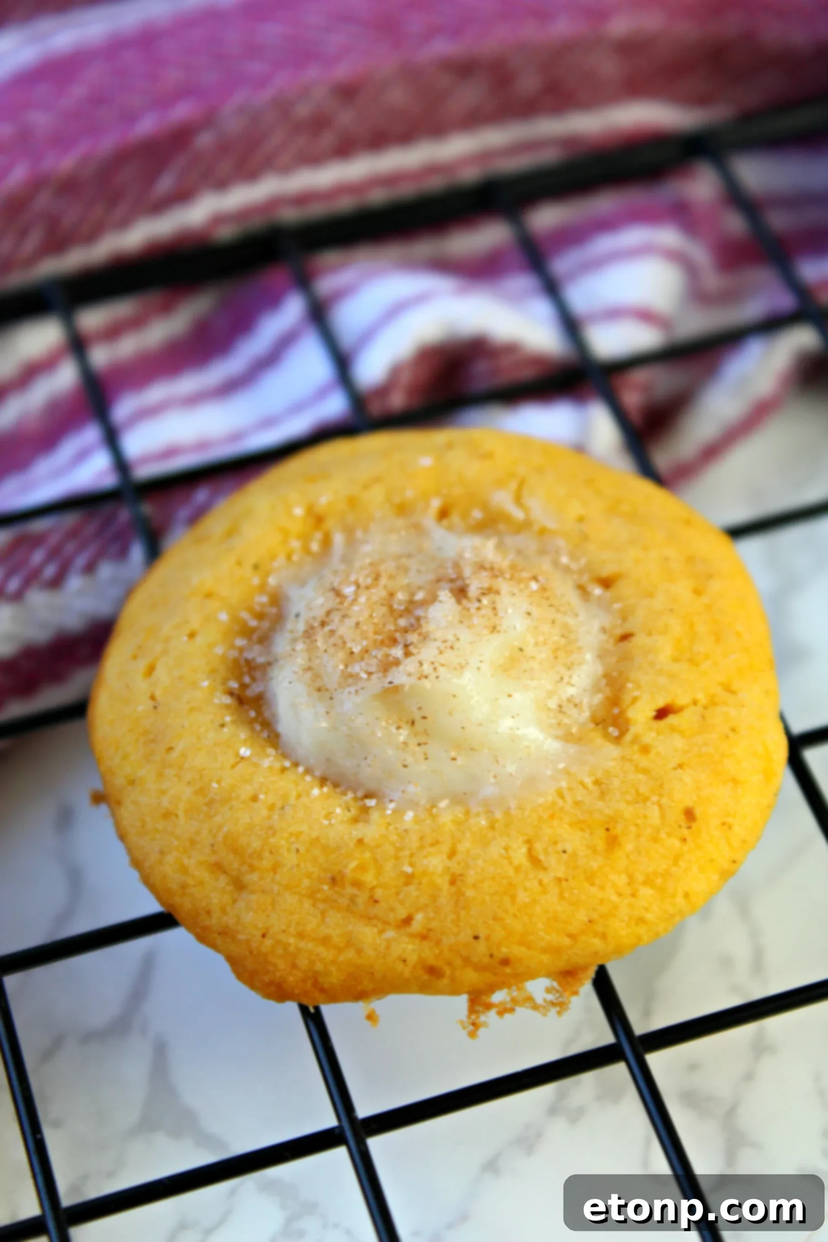 A final close-up of pumpkin cheesecake thumbprint cookies, showing their delightful cinnamon sugar dusting