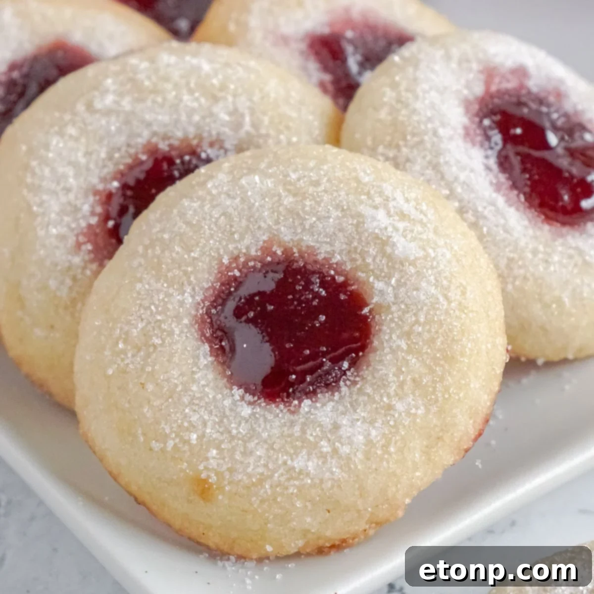 Raspberry Thumbprint Cookies arranged beautifully on a white platter