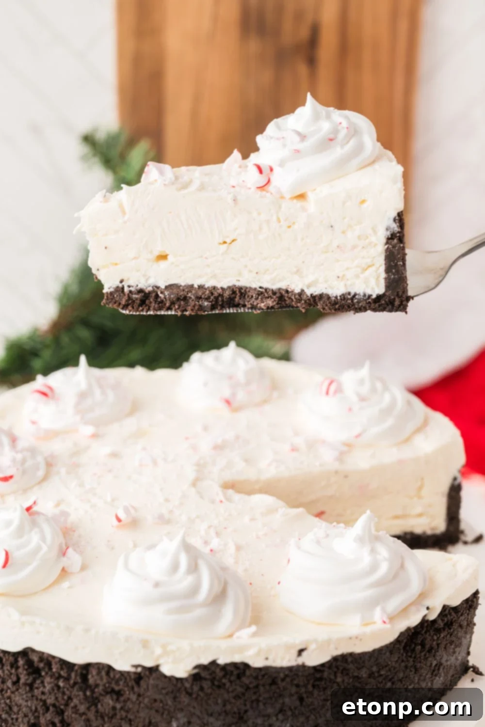 Peppermint Dream Cheesecake: A Festive No-Bake Delight 14 Lifting a slice of No Bake Peppermint Cheesecake