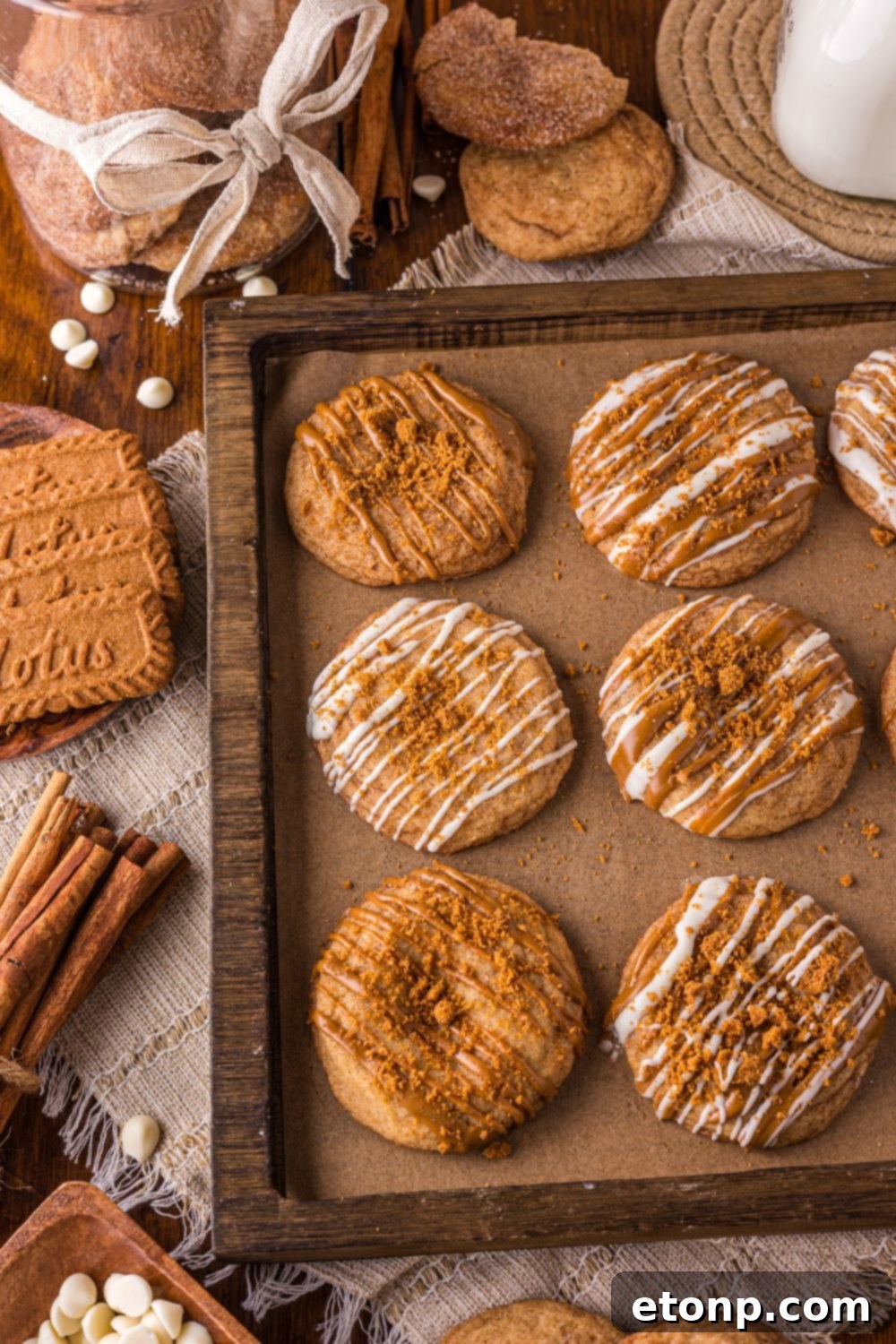 Biscoff Bliss: Soft-Baked Cinnamon Butter Cookies 21 Biscoff Snickerdoodle Cookies on a baking sheet with cinnamon sticks