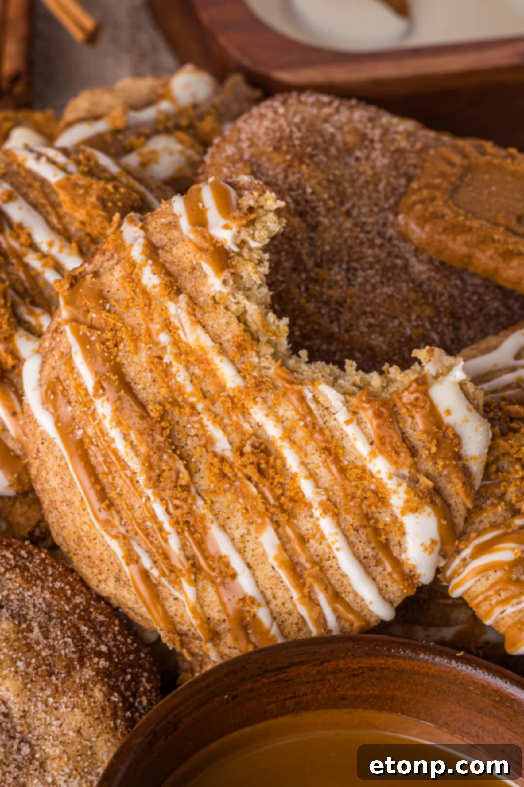 Biscoff Bliss: Soft-Baked Cinnamon Butter Cookies 22 Biscoff Snickerdoodle Cookie with a bite missing