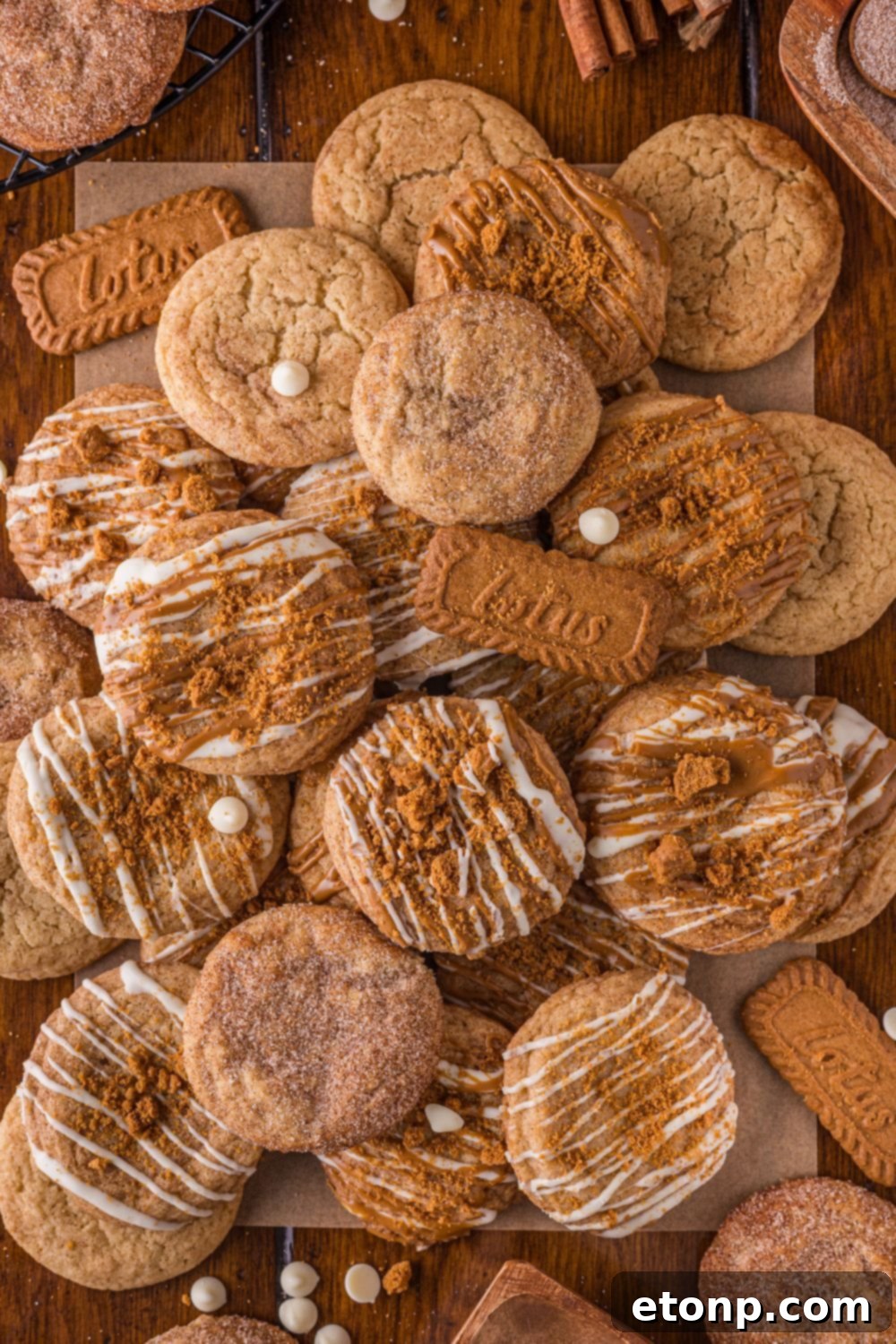 Biscoff Bliss: Soft-Baked Cinnamon Butter Cookies 28 Biscoff Snickerdoodle Cookies piled on the table with white chocolate chips