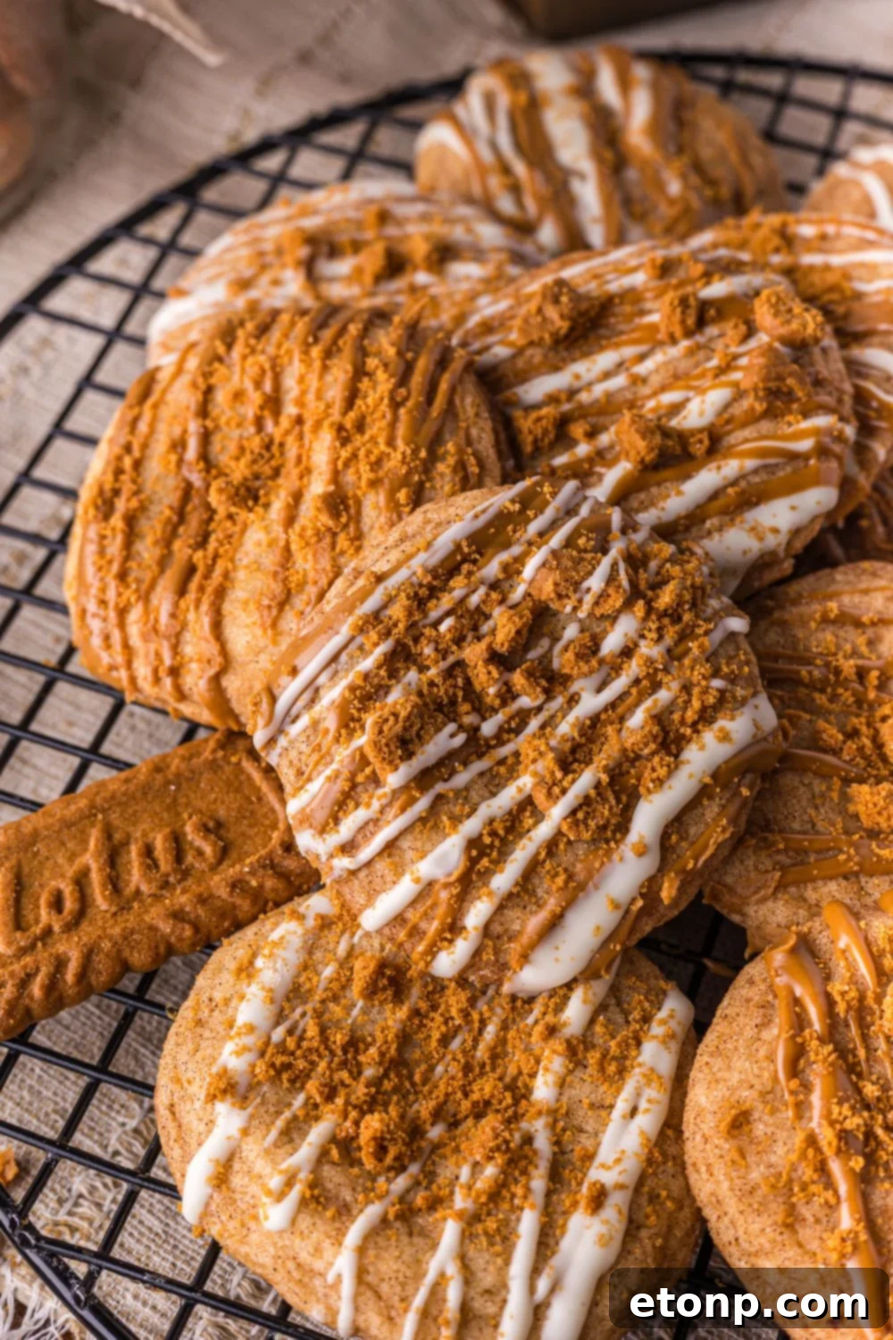 Biscoff Bliss: Soft-Baked Cinnamon Butter Cookies 5 Biscoff Snickerdoodle Cookies stacked on a wire cooling rack