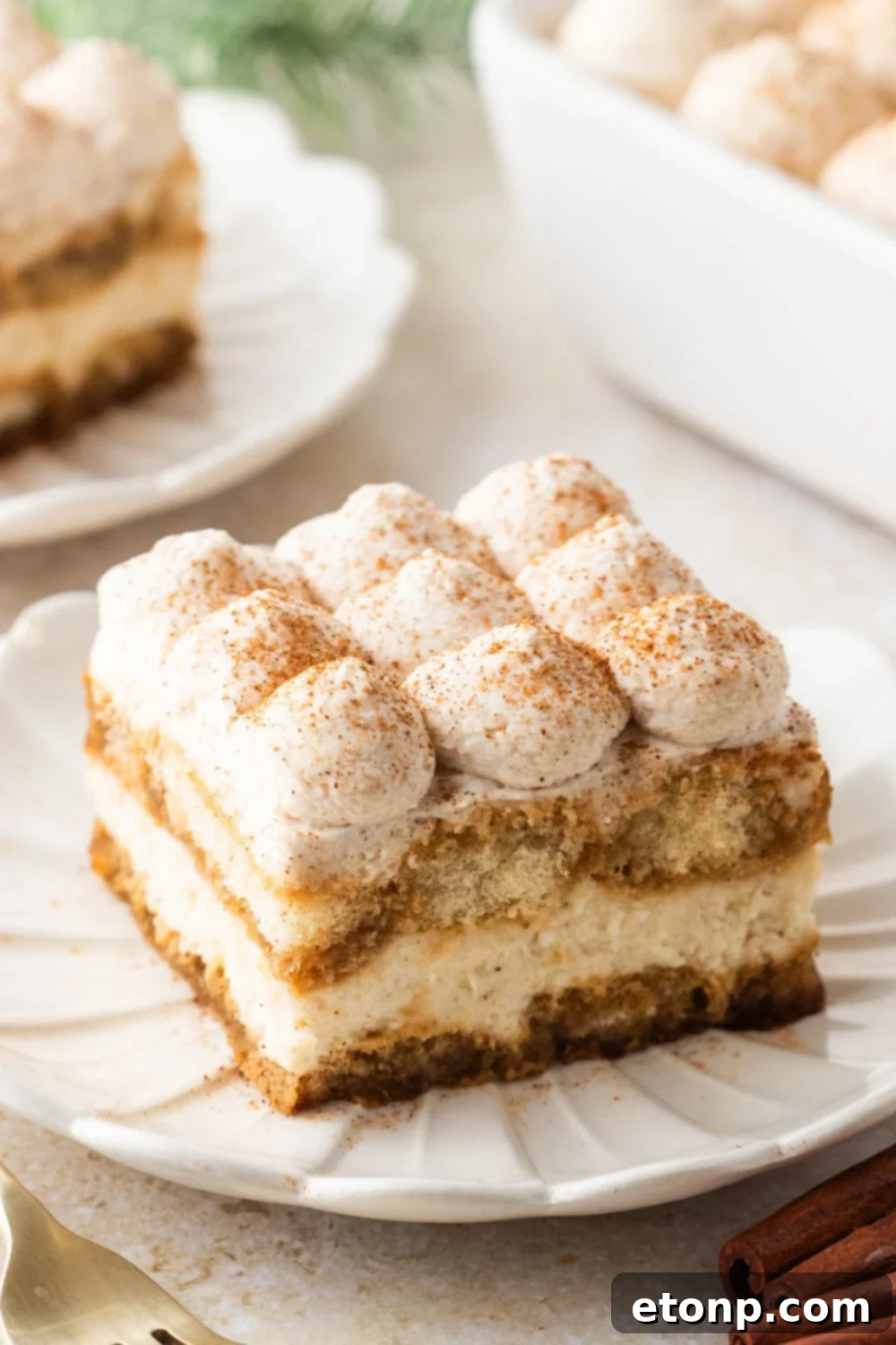 Eggnog Tiramisu: A Festive Holiday Treat 26 Pan full of tiramisu with plates around table with slices of the tiramisu