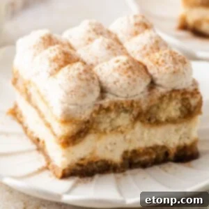 Eggnog Tiramisu: A Festive Holiday Treat 29 slice of Eggnog Tiramisu on a white plate on table