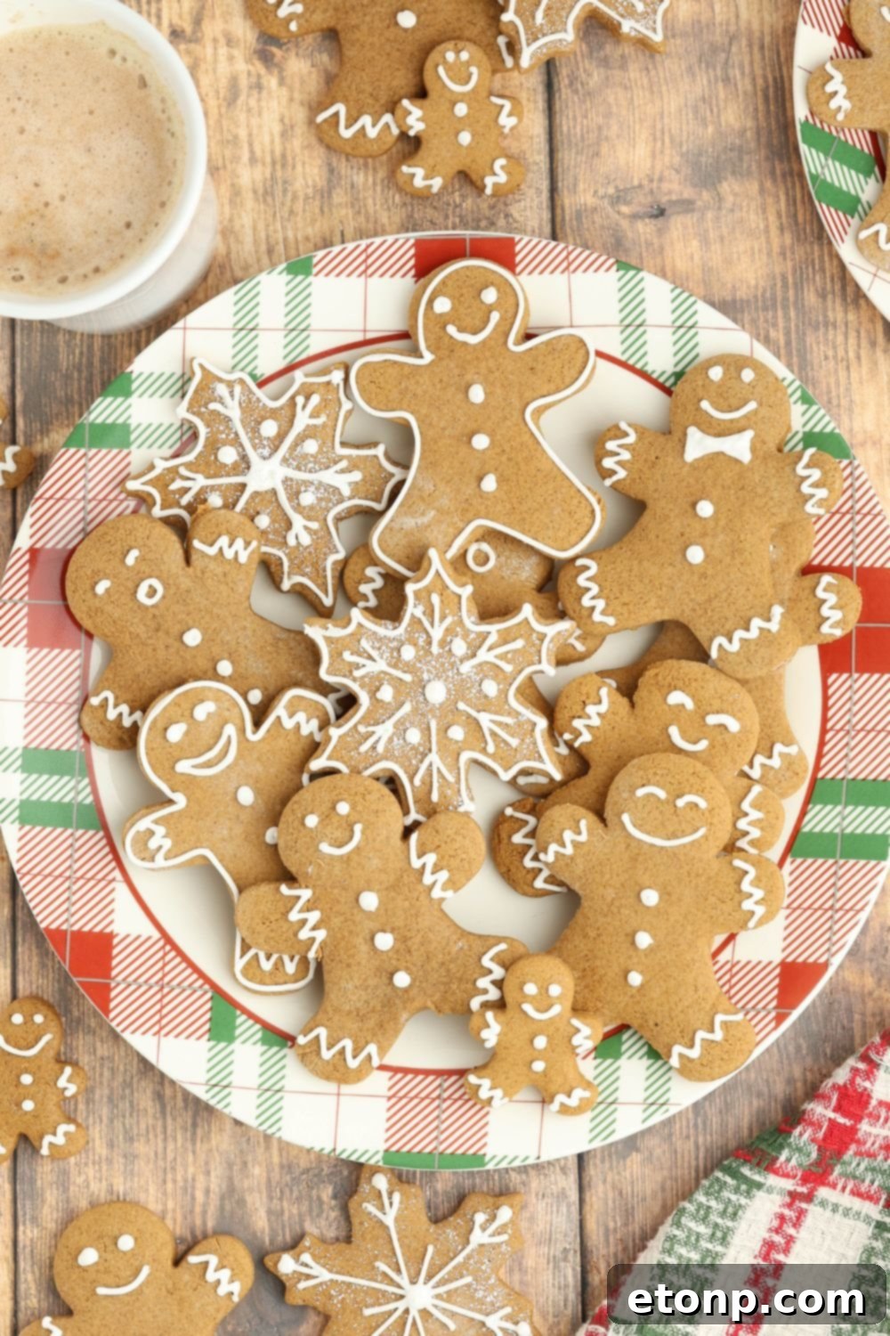 Colorful plate full of different shapes of Christmas gingerbread cookies.
