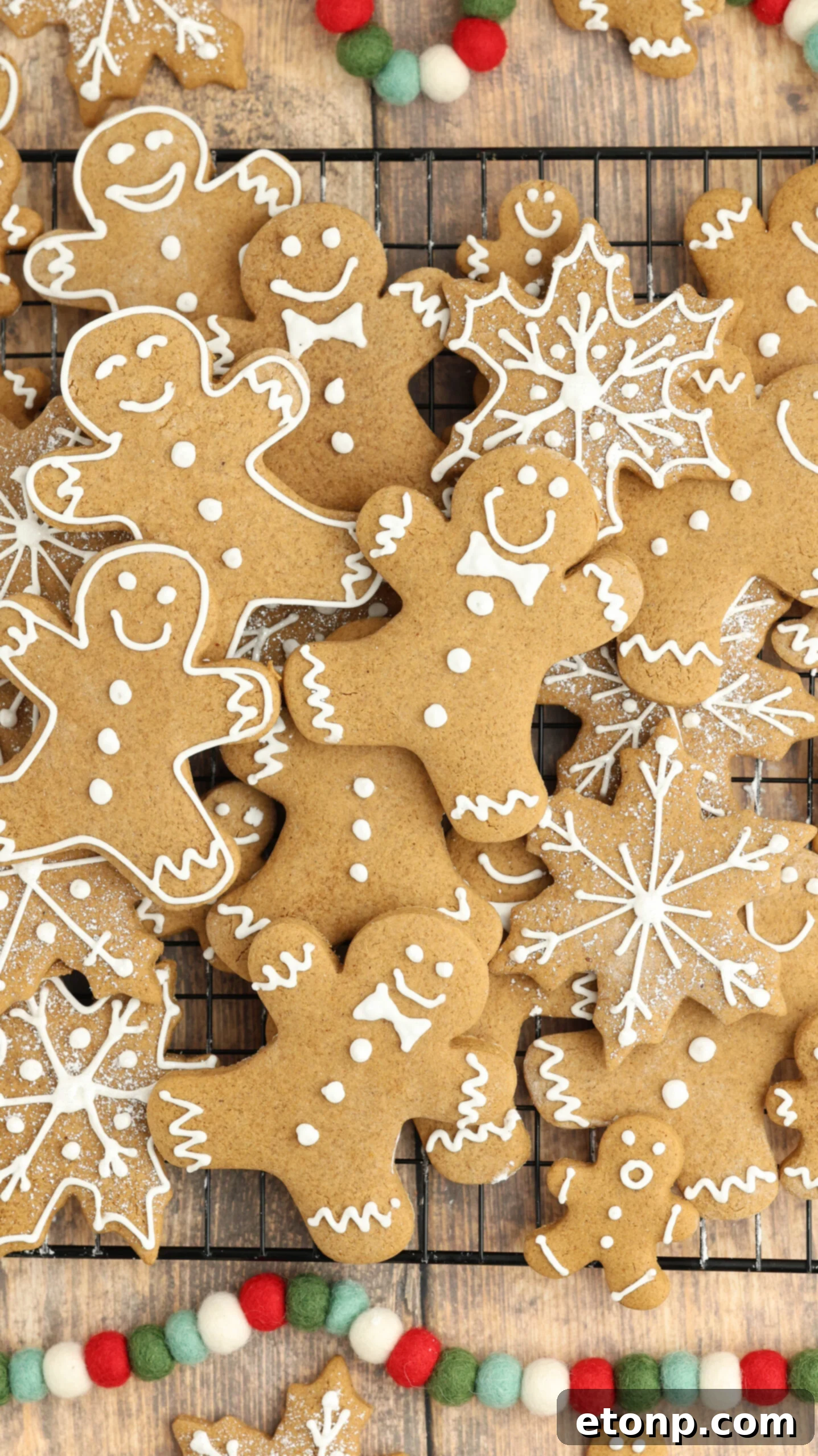 Cooling rack with different shapes of Christmas gingerbread cookies.