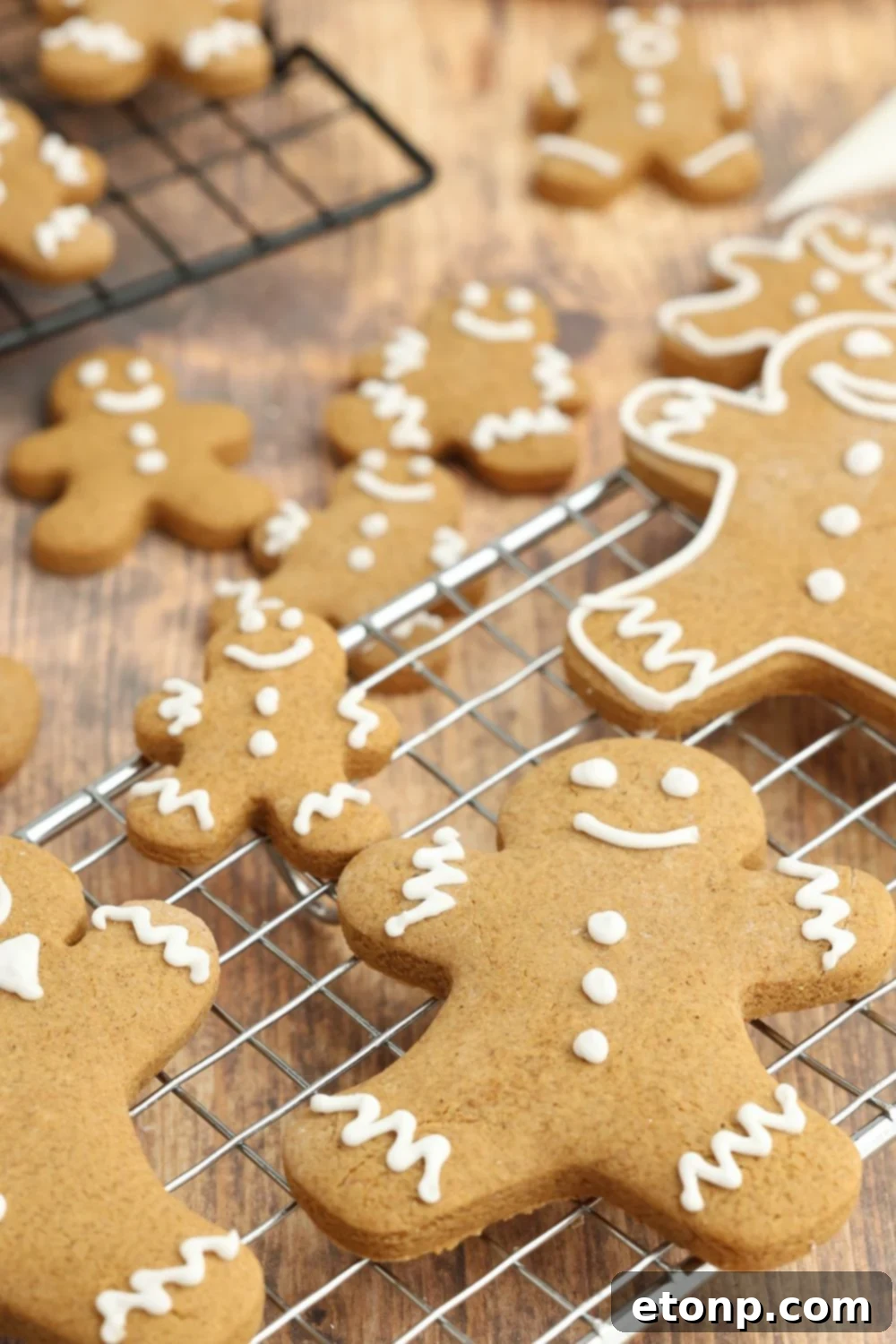 Different sized gingerbread cookies on a cooling rack.
