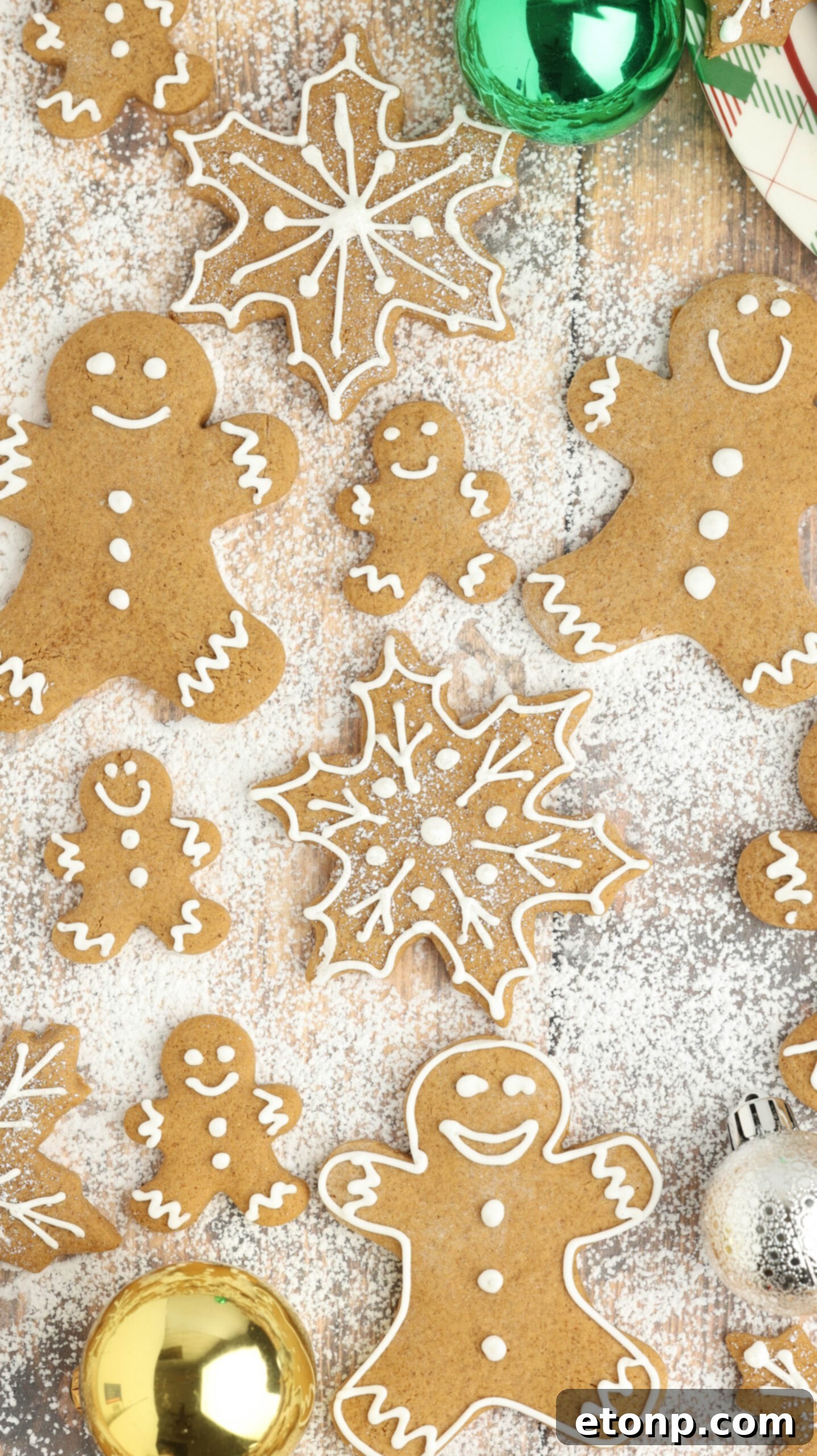 A table full of Christmas gingerbread cookies, many covered in powdered sugar.