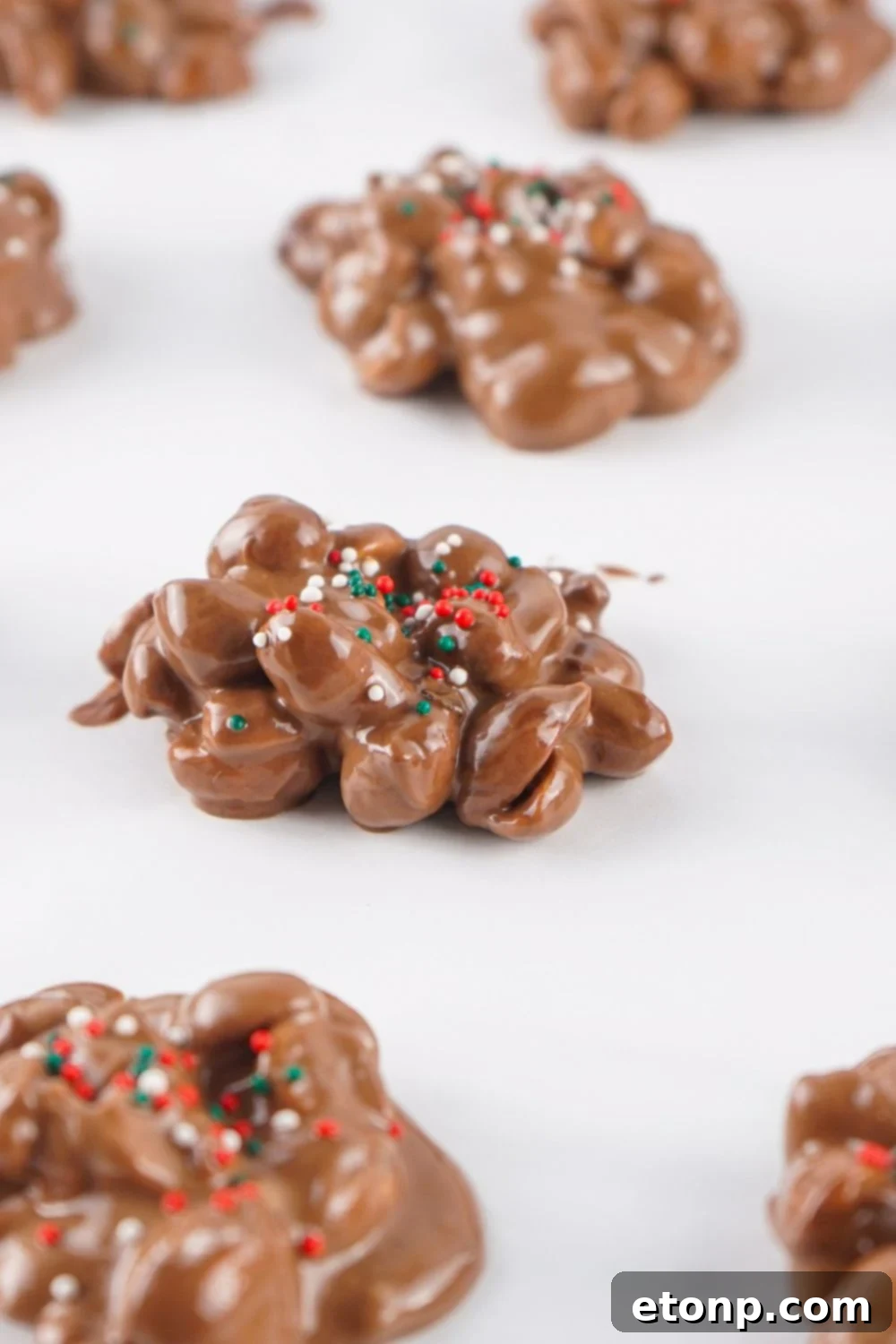 Slow Cooker Holiday Fudge: 4-Ingredient Magic 11 Crockpot Christmas Candy on parchment paper with sprinkles