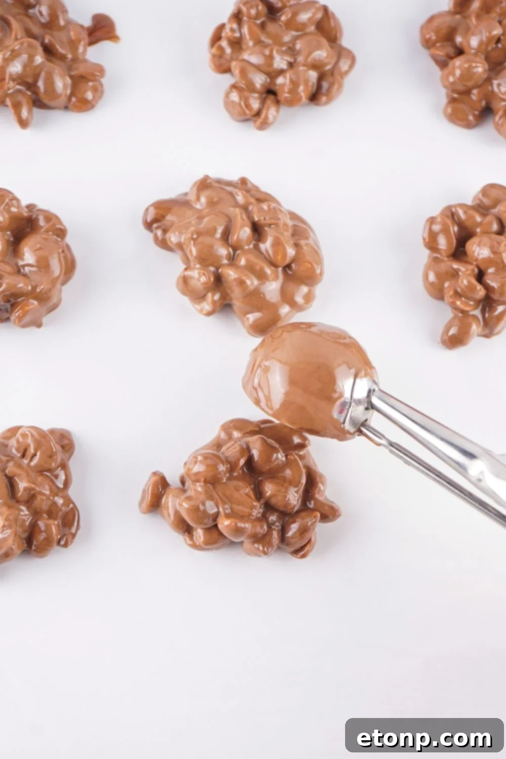Slow Cooker Holiday Fudge: 4-Ingredient Magic 10 Spoon candy on parchment paper