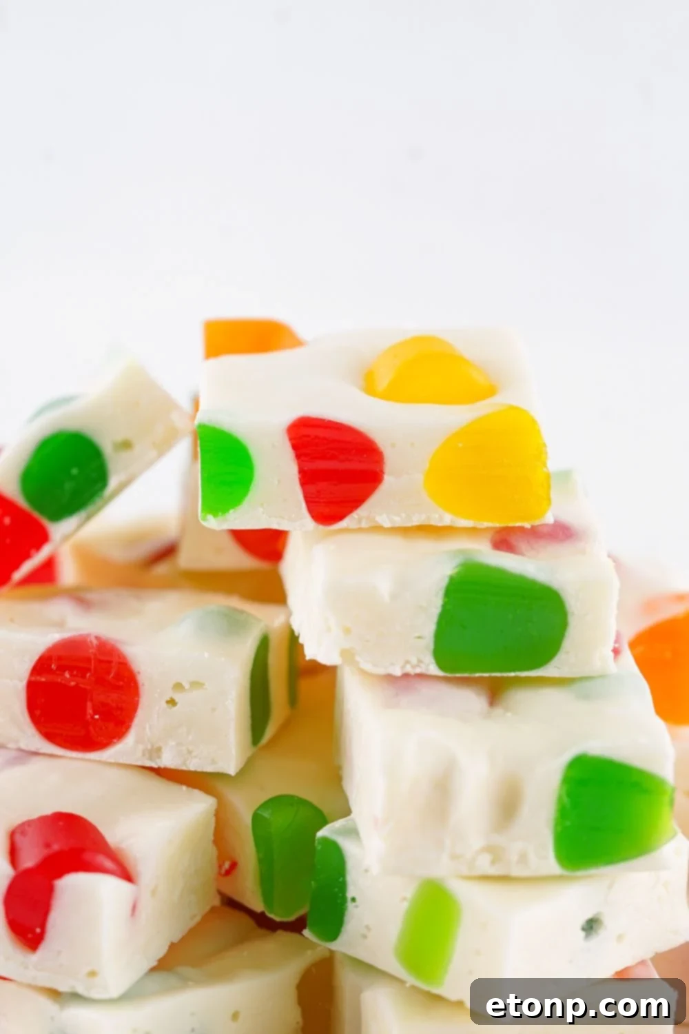 Holiday Gumdrop Nougat: A Nostalgic Christmas Treat 16 Christmas Gumdrop Nougat Candy stacked on top of one another with white background