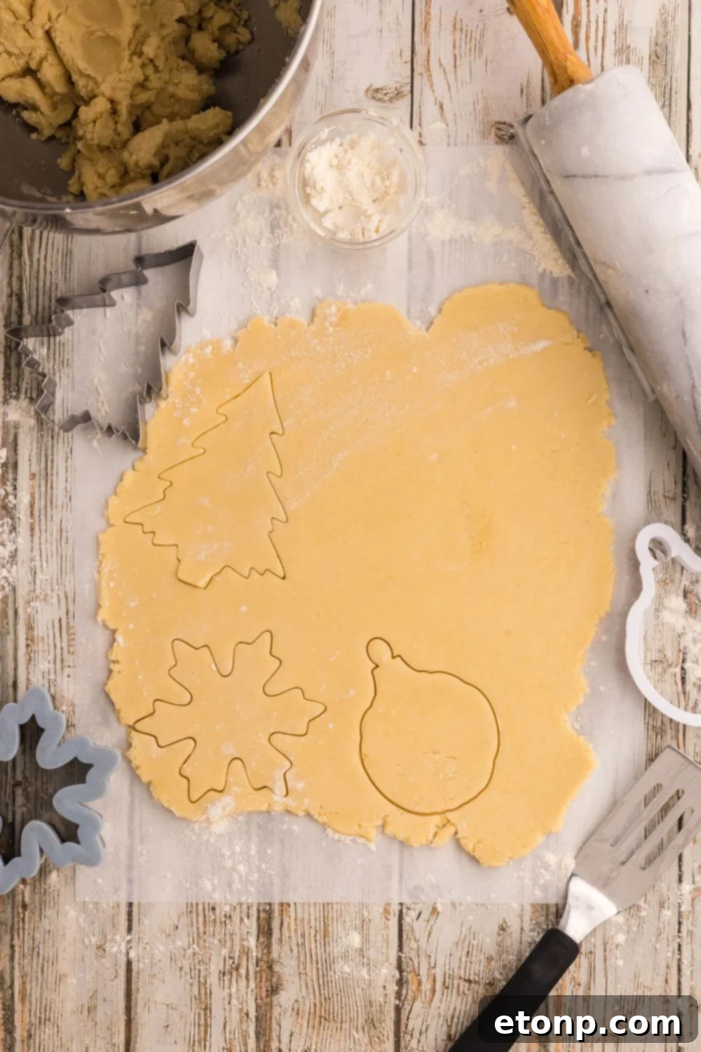Adorned Sugar Cookies: Soft, Shapely, and Icing-Ready 11 Rolled-out sugar cookie dough with Christmas shapes.