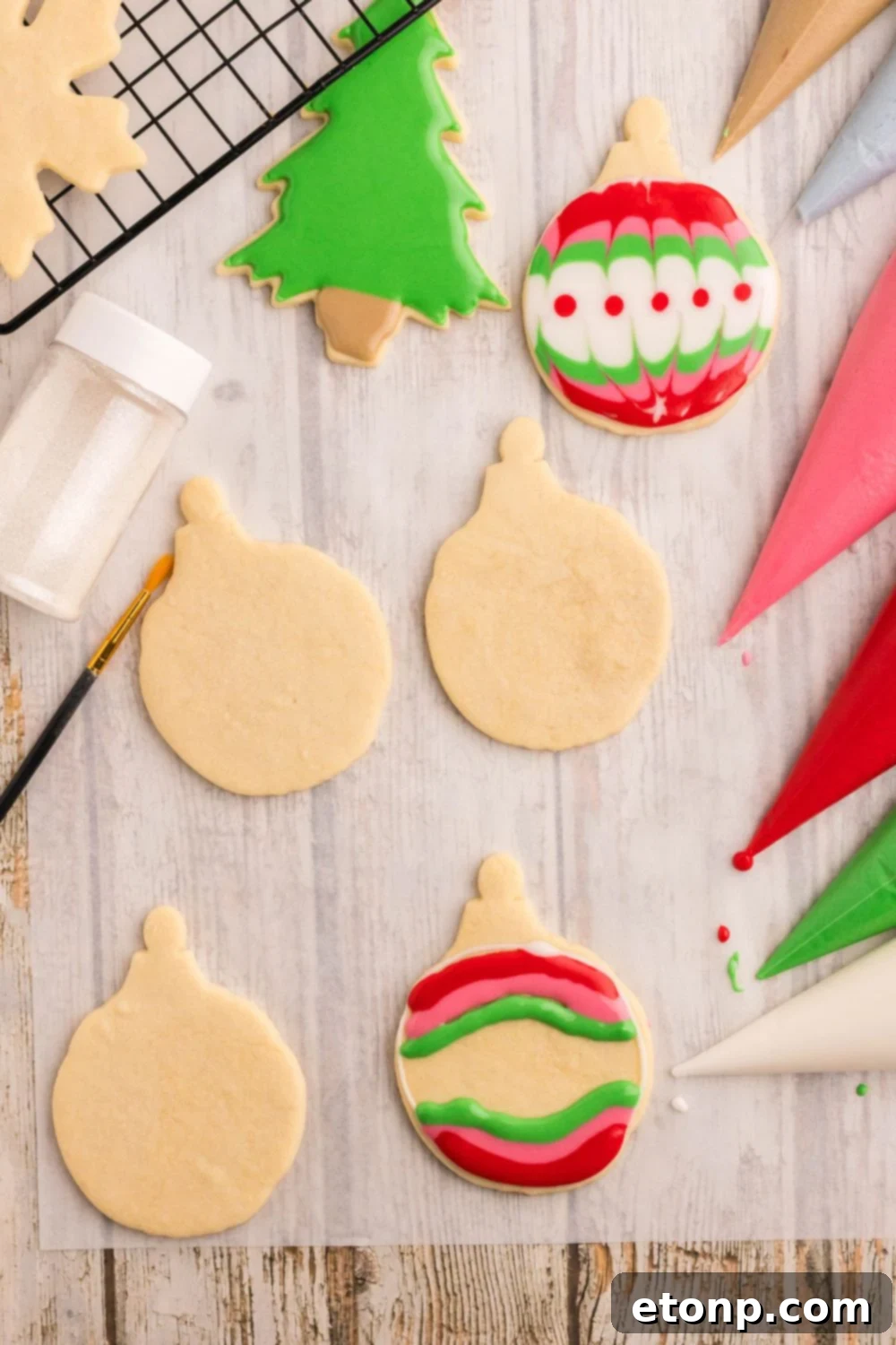 Adorned Sugar Cookies: Soft, Shapely, and Icing-Ready 18 Christmas ornaments being decorated with royal icing.