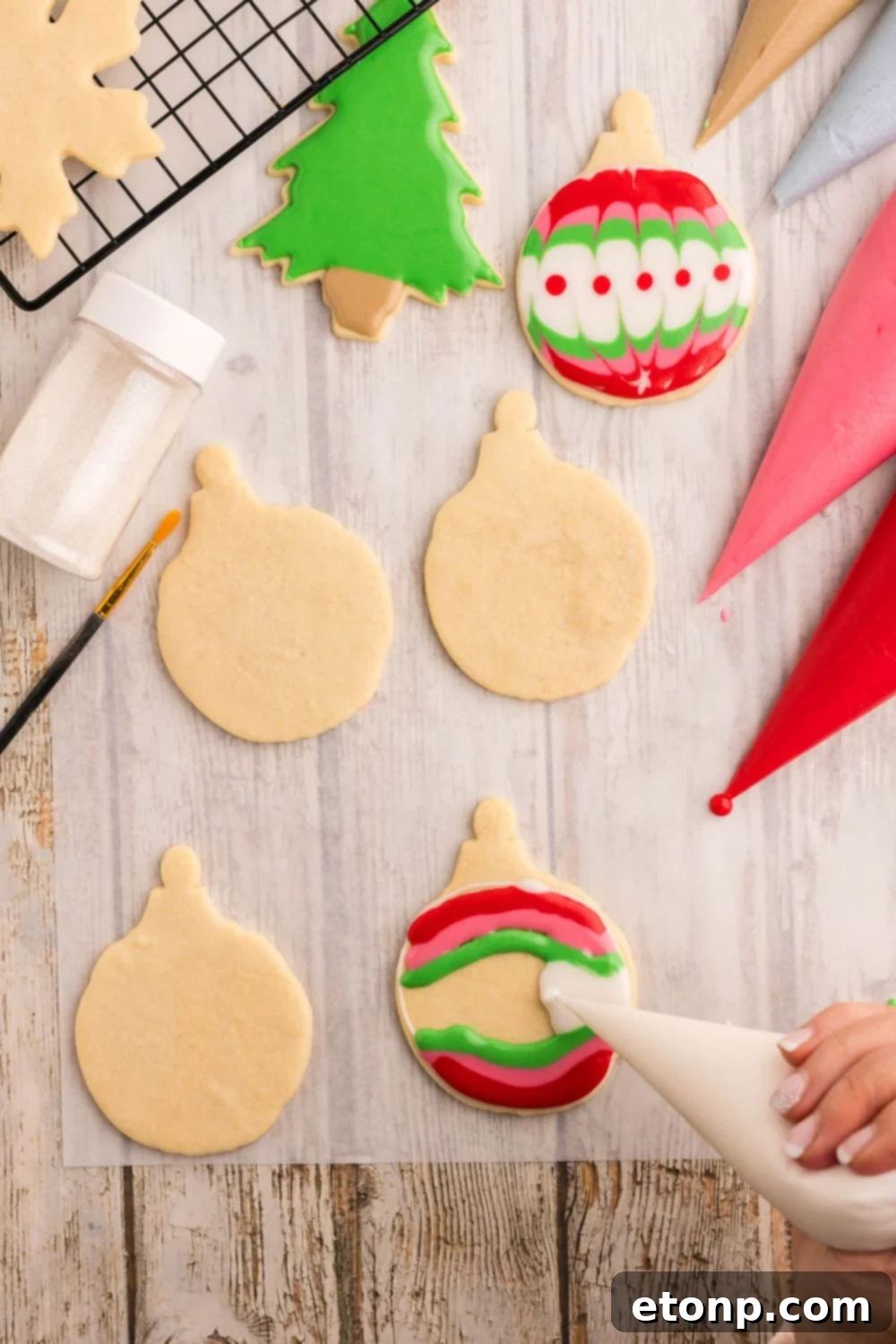 Adorned Sugar Cookies: Soft, Shapely, and Icing-Ready 20 Christmas ornament-shaped cookie being decorated with royal icing.