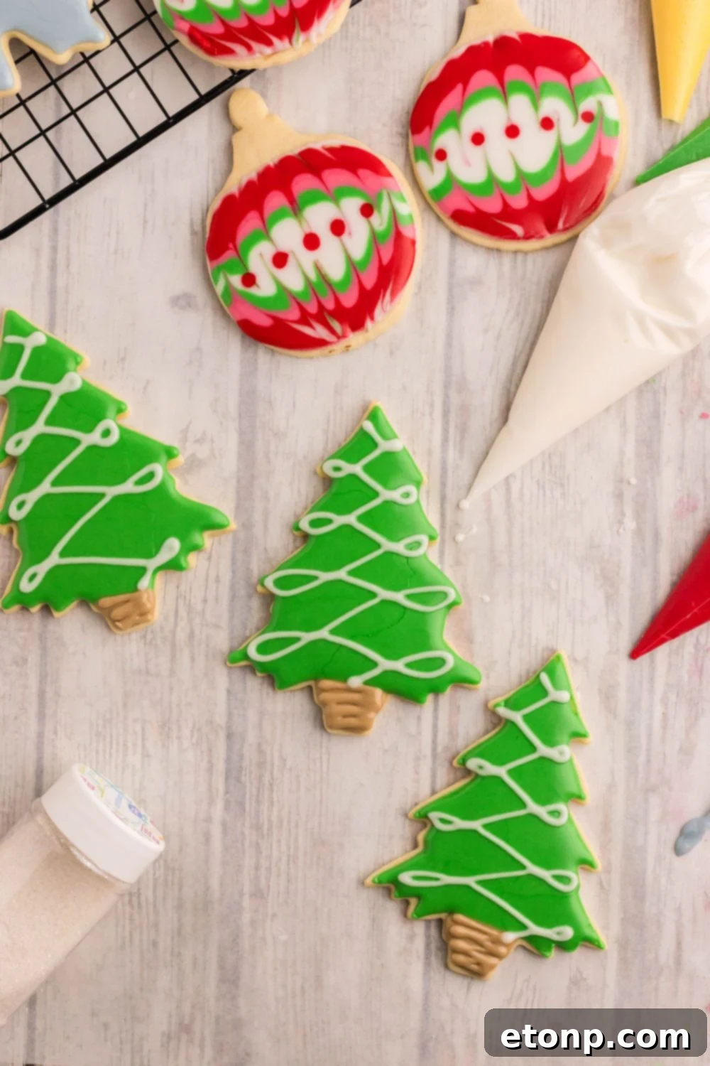 Adorned Sugar Cookies: Soft, Shapely, and Icing-Ready 22 Decorated Sugar Cookies shaped like Christmas trees with lights.