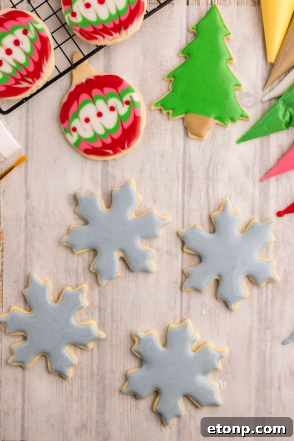 Adorned Sugar Cookies: Soft, Shapely, and Icing-Ready 25 Decorated Sugar Cookies shaped like Christmas ornaments and snowflakes.