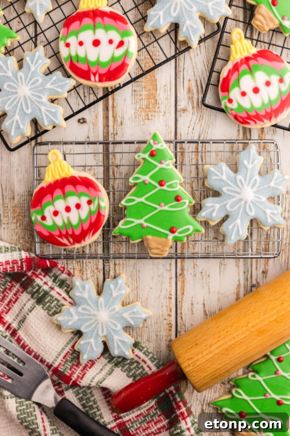 Adorned Sugar Cookies: Soft, Shapely, and Icing-Ready 26 Cooling rack with Christmas-shaped ornaments and a rolling pin.