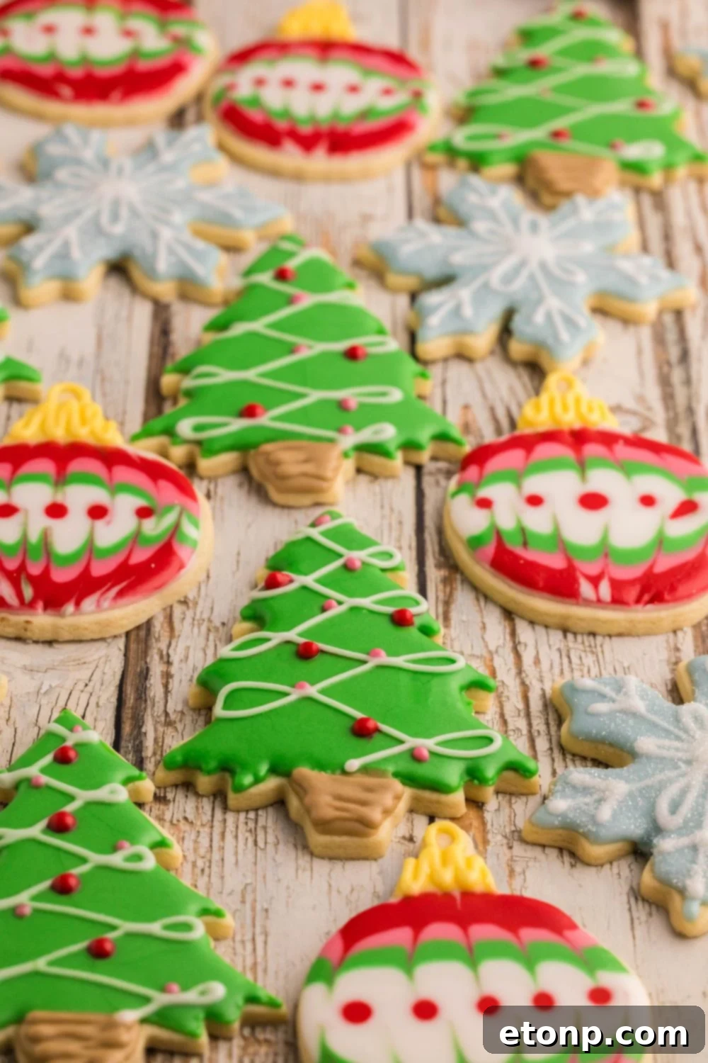Adorned Sugar Cookies: Soft, Shapely, and Icing-Ready 4 Decorated Sugar Cookies shaped like snowflakes, trees, and ornaments.