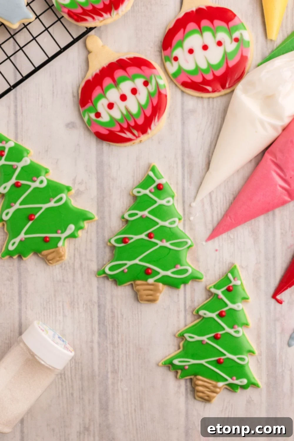 Adorned Sugar Cookies: Soft, Shapely, and Icing-Ready 34 Piping bags with royal icing and Christmas tree cookies.