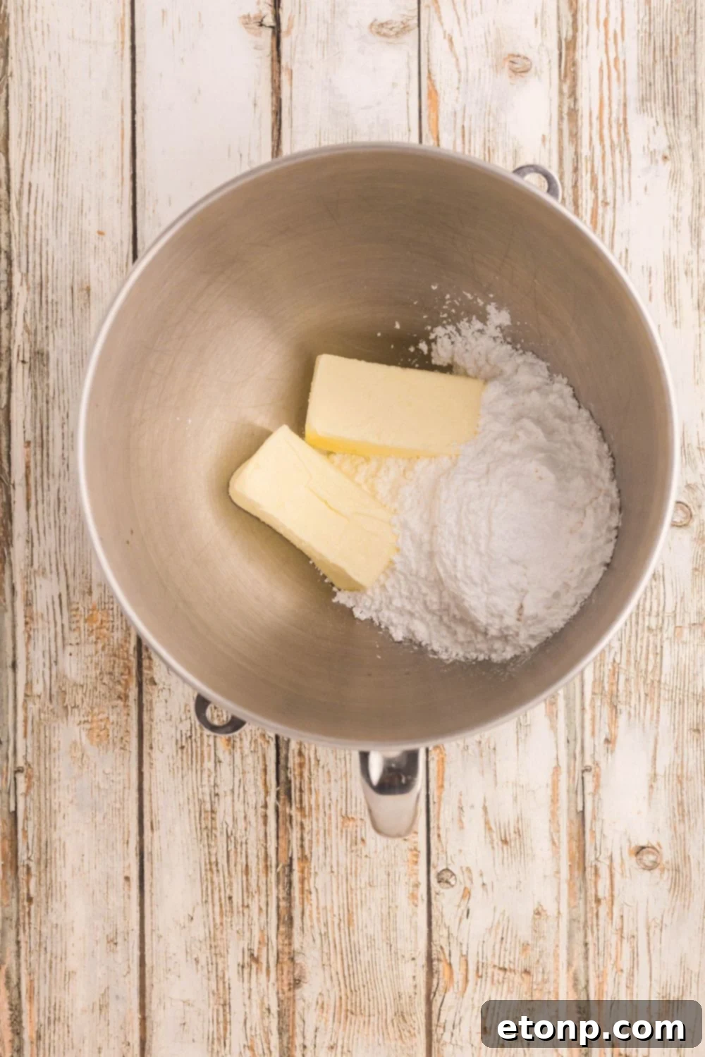 Adorned Sugar Cookies: Soft, Shapely, and Icing-Ready 8 Butter and powdered sugar in a metal bowl.