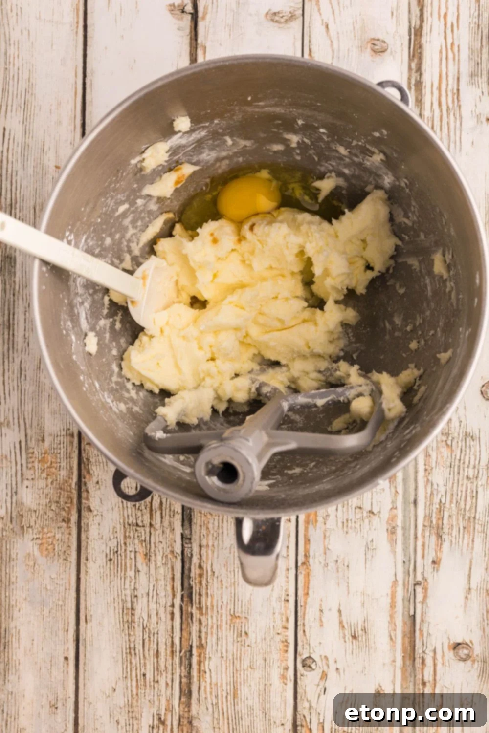 Adorned Sugar Cookies: Soft, Shapely, and Icing-Ready 9 Sugar cookie batter being mixed with an egg.