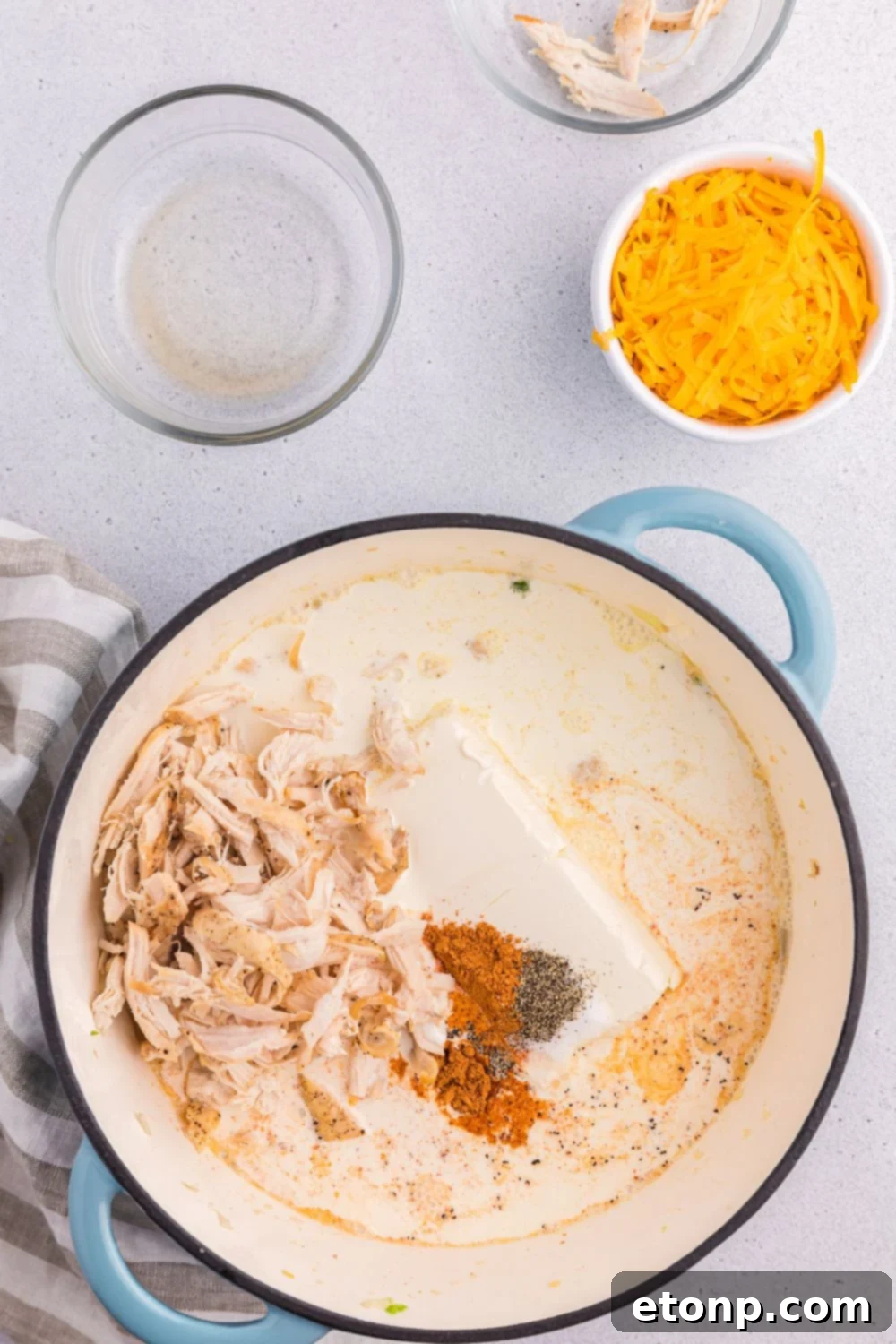 Chicken with cream cheese and spices together in a pot