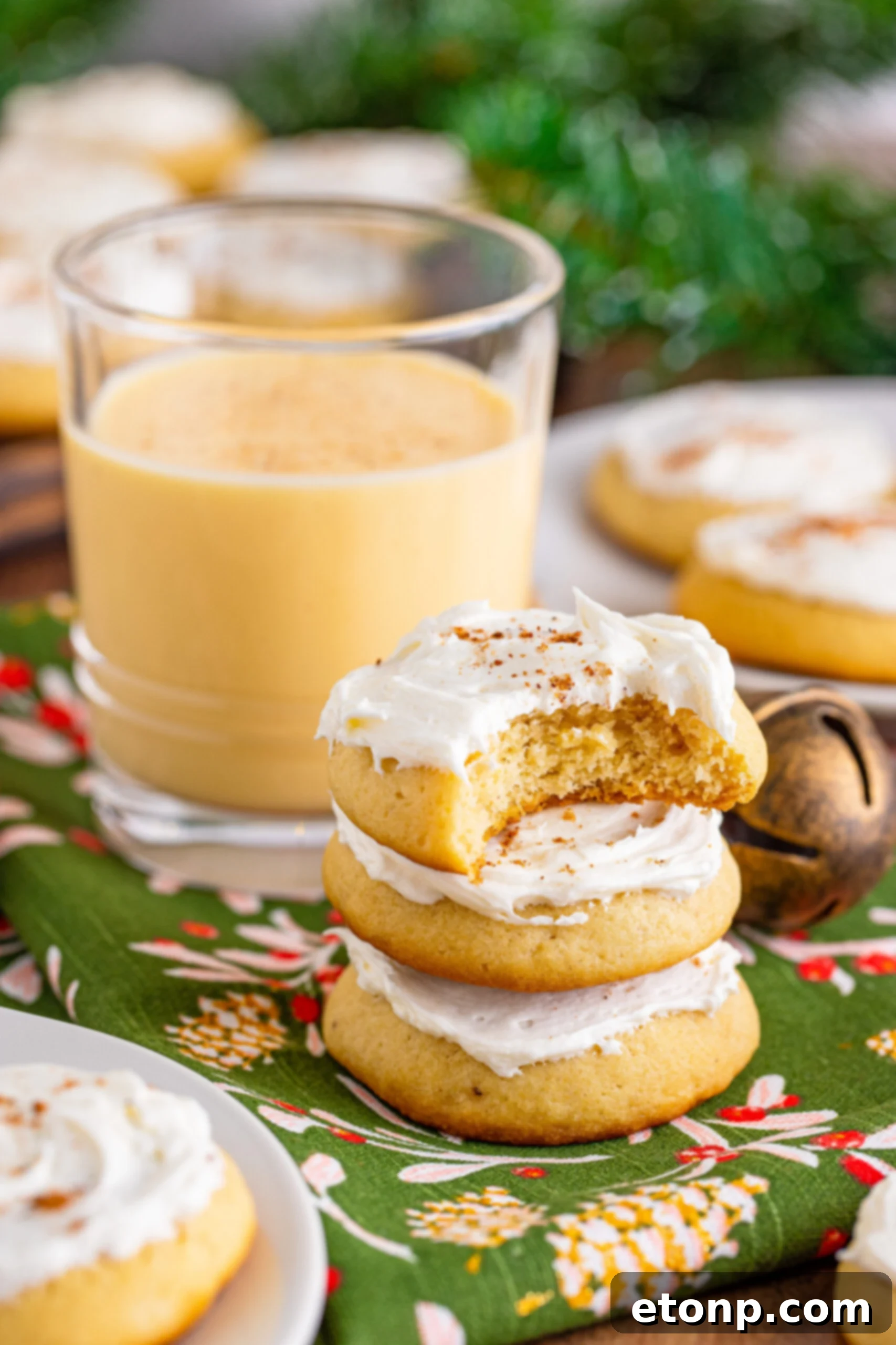 Soft Frosted Eggnog Cookies (Bakery Style Holiday Cookies) Delectable Holiday Eggnog Delights 2 Soft Frosted Eggnog Cookies stacked with a bite missing