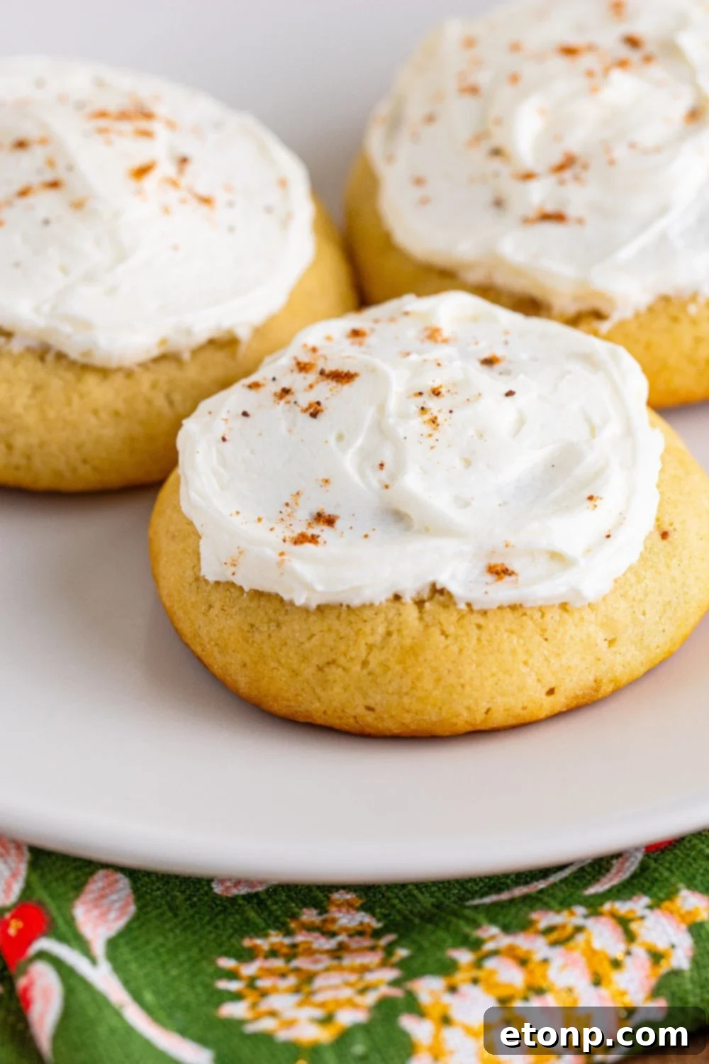 Soft Frosted Eggnog Cookies (Bakery Style Holiday Cookies) Delectable Holiday Eggnog Delights 17 White plate with Soft Frosted Eggnog Cookies