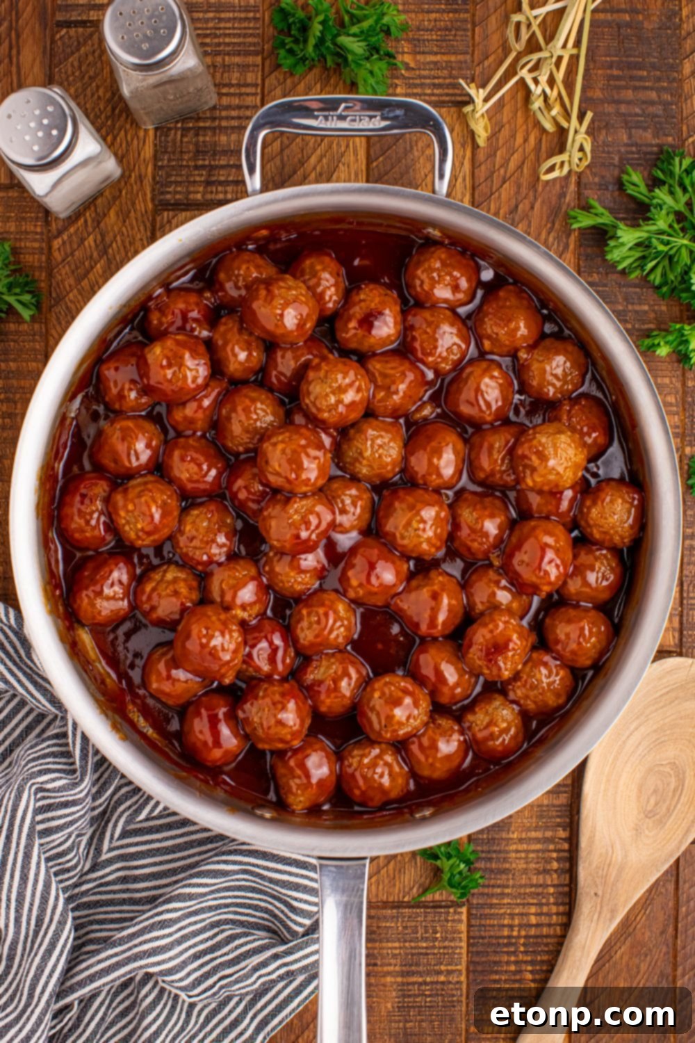 A large skillet filled with Peach BBQ Meatballs, perfect for a party or gathering.
