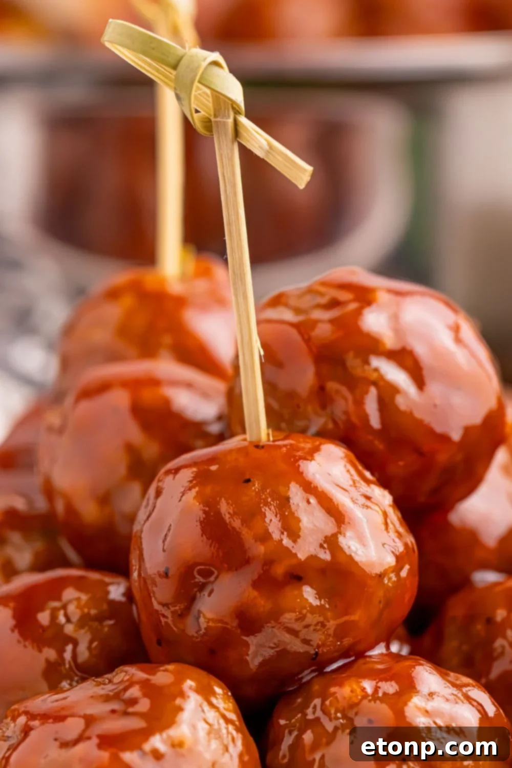 Peach BBQ Meatballs on a plate with toothpicks.