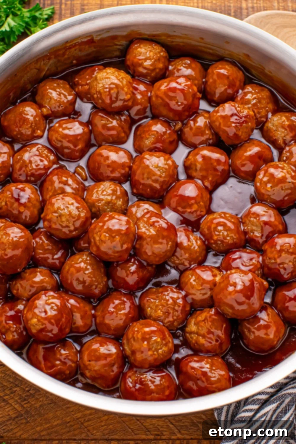 An overhead view of a skillet filled with Peach BBQ Meatballs.