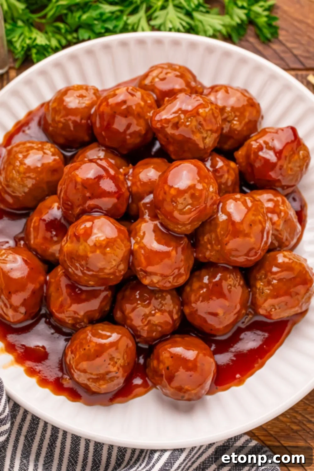Peach BBQ Meatballs piled high on a white plate.