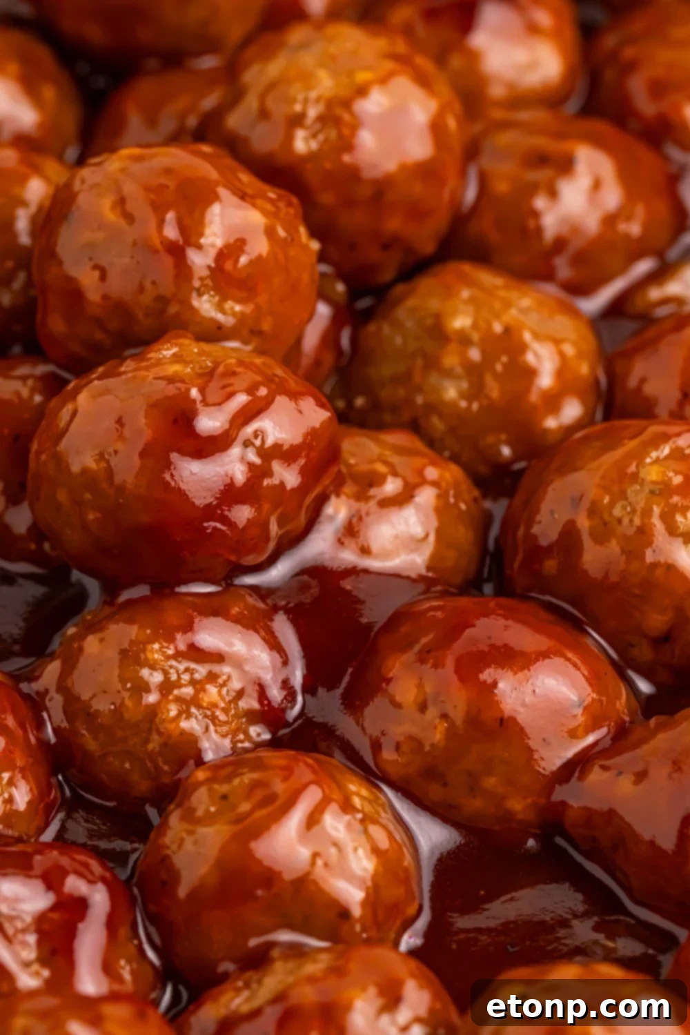 Peach BBQ Meatballs cooking in a skillet, showcasing the delicious sauce.