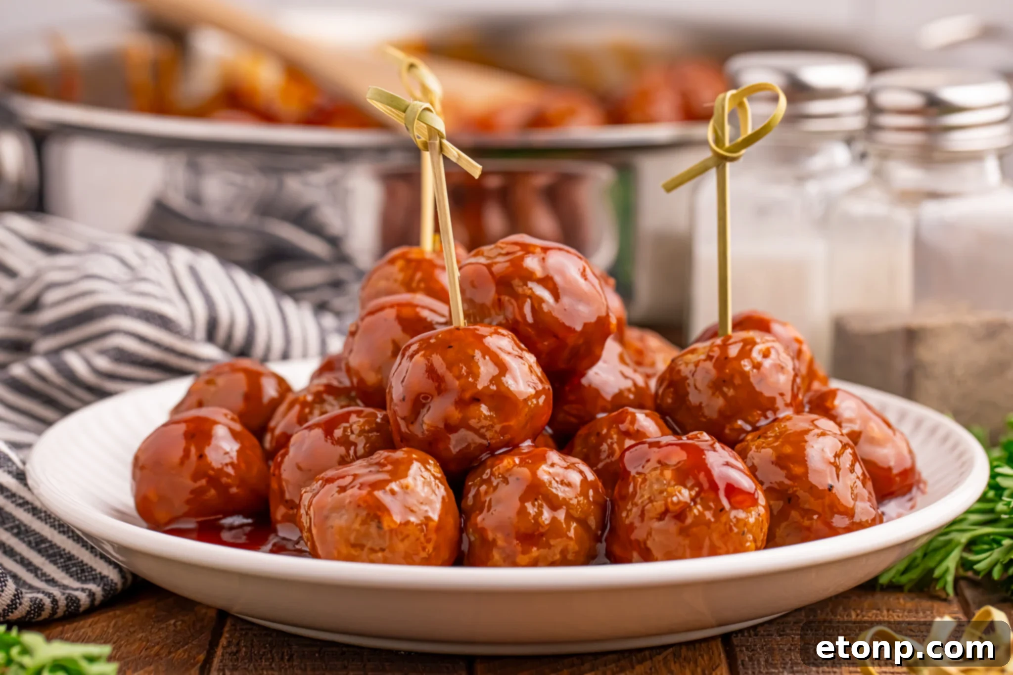 A plate of Peach BBQ Meatballs with toothpicks, ready to be enjoyed.