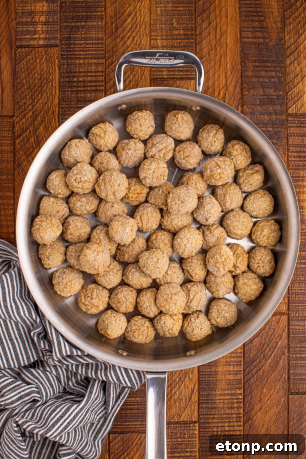 Frozen meatballs in a skillet before cooking.