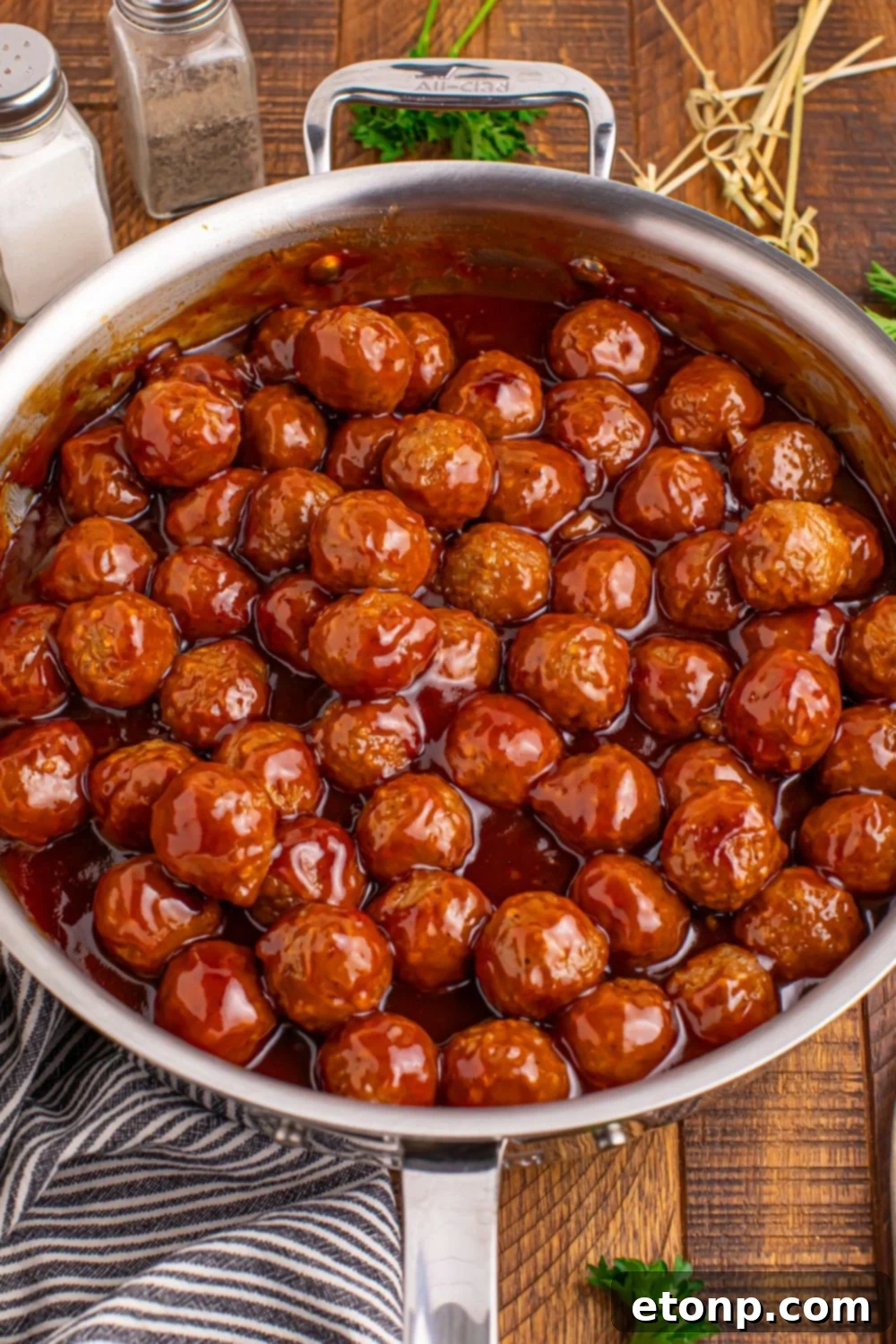 A skillet full of deliciously glazed Peach BBQ Meatballs.