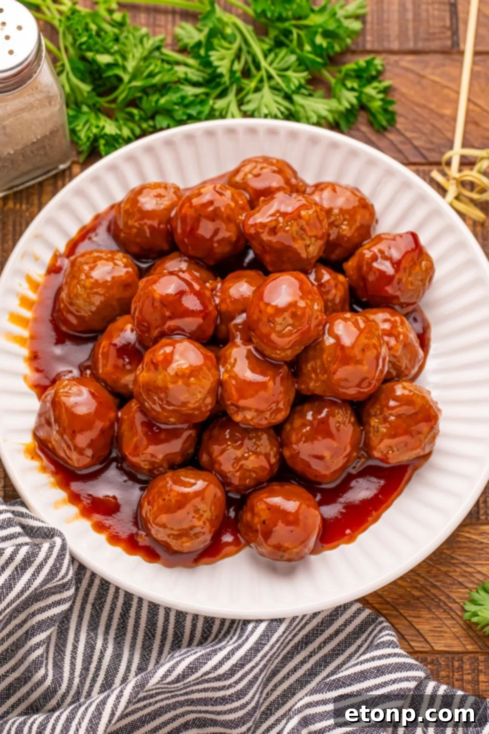 A white plate piled high with tempting Peach BBQ Meatballs.