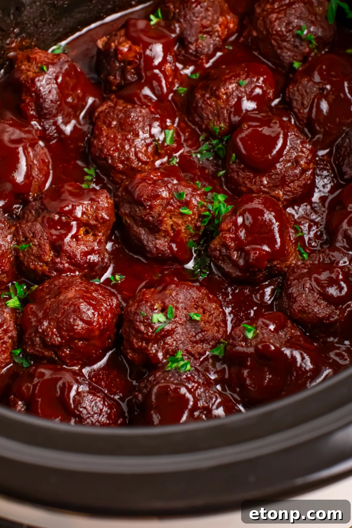 Slow-Cooker BBQ Meatball Magic 2 Crockpot Homemade BBQ Meatballs simmering in a black slow cooker