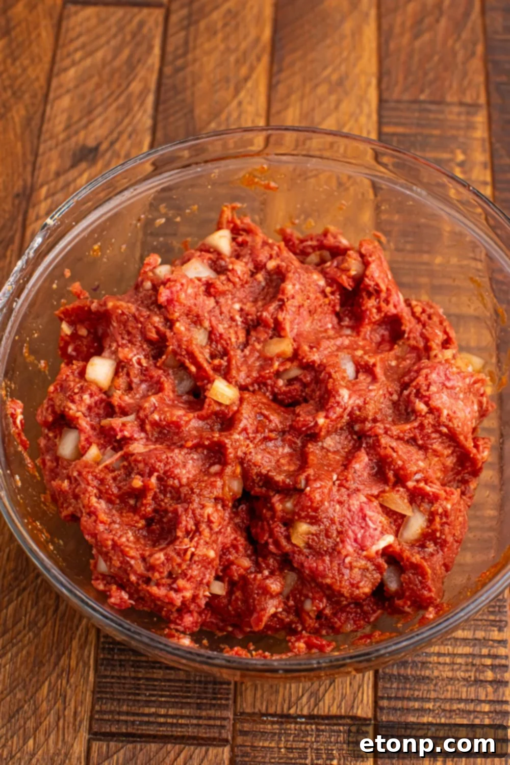 Slow-Cooker BBQ Meatball Magic 11 A bowl of raw meat mixture ready to be formed into meatballs