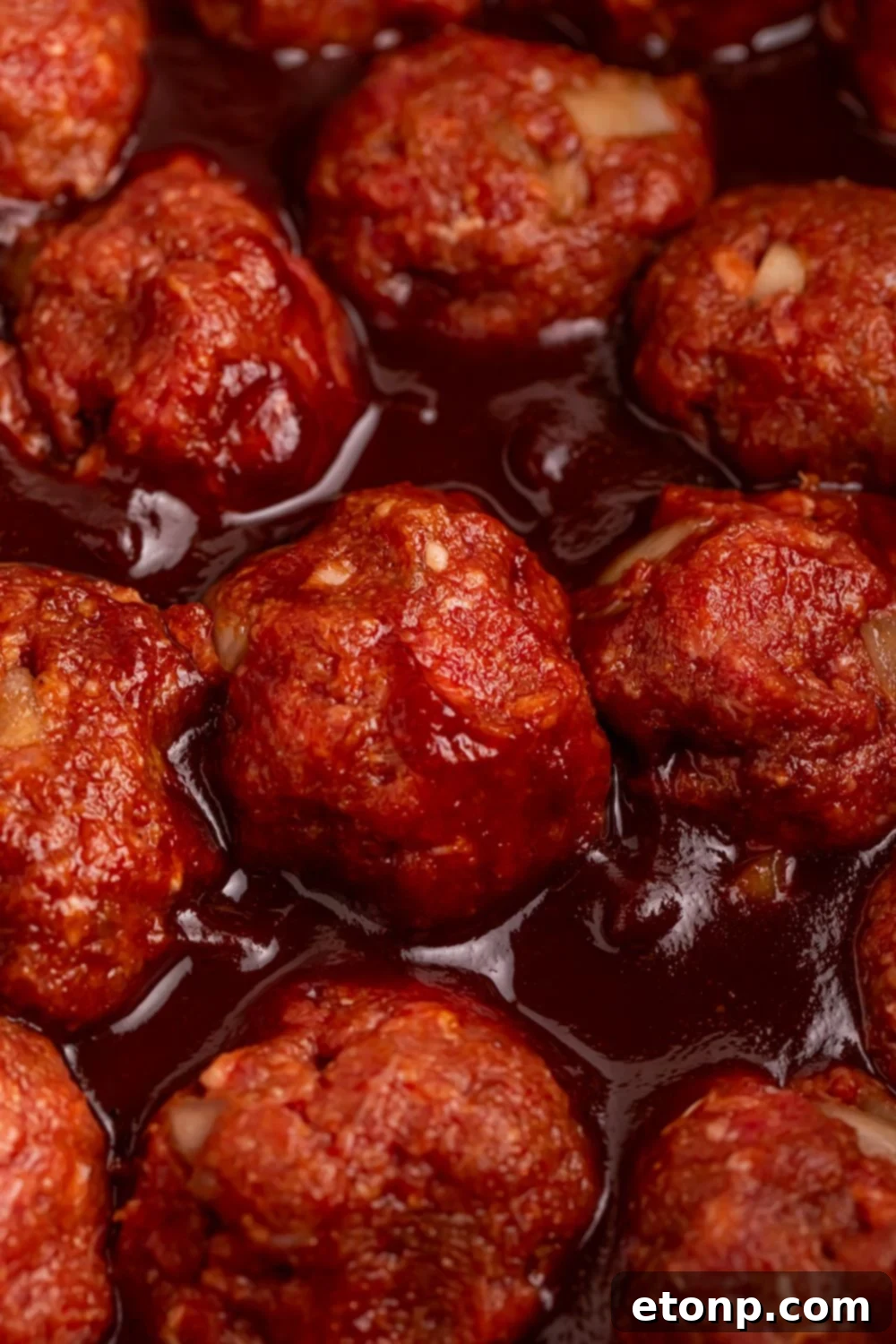 Slow-Cooker BBQ Meatball Magic 13 Close-up of the meatballs simmering in BBQ sauce in the CrockPot