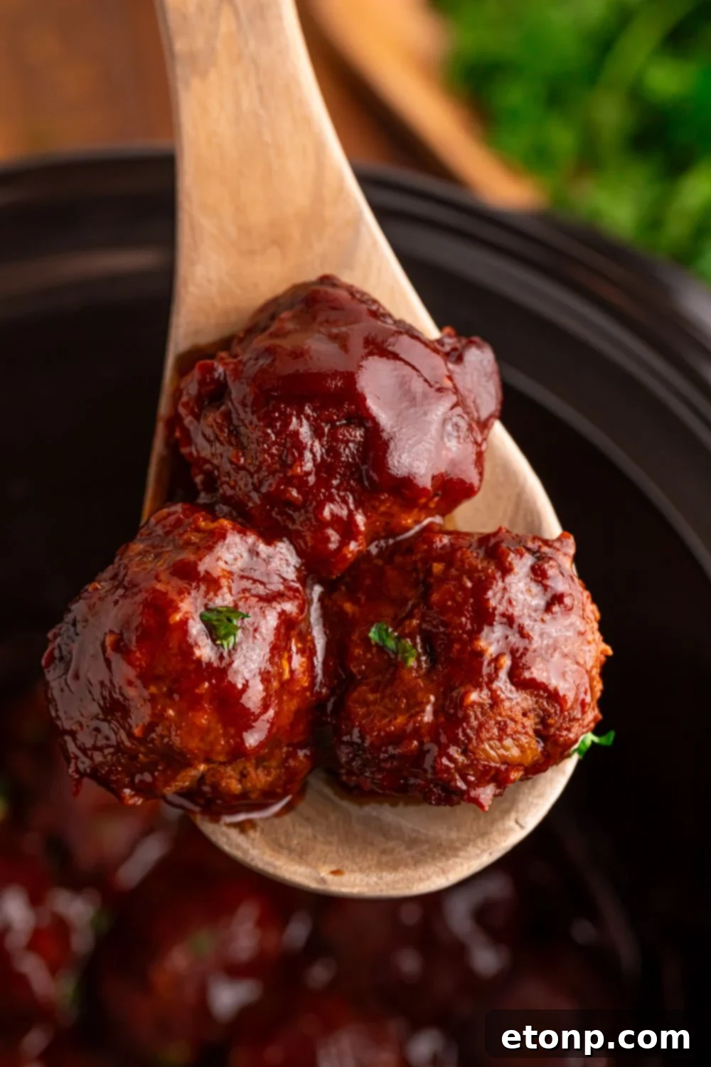 Slow-Cooker BBQ Meatball Magic 16 Crockpot Homemade BBQ Meatballs being scooped out of the CrockPot