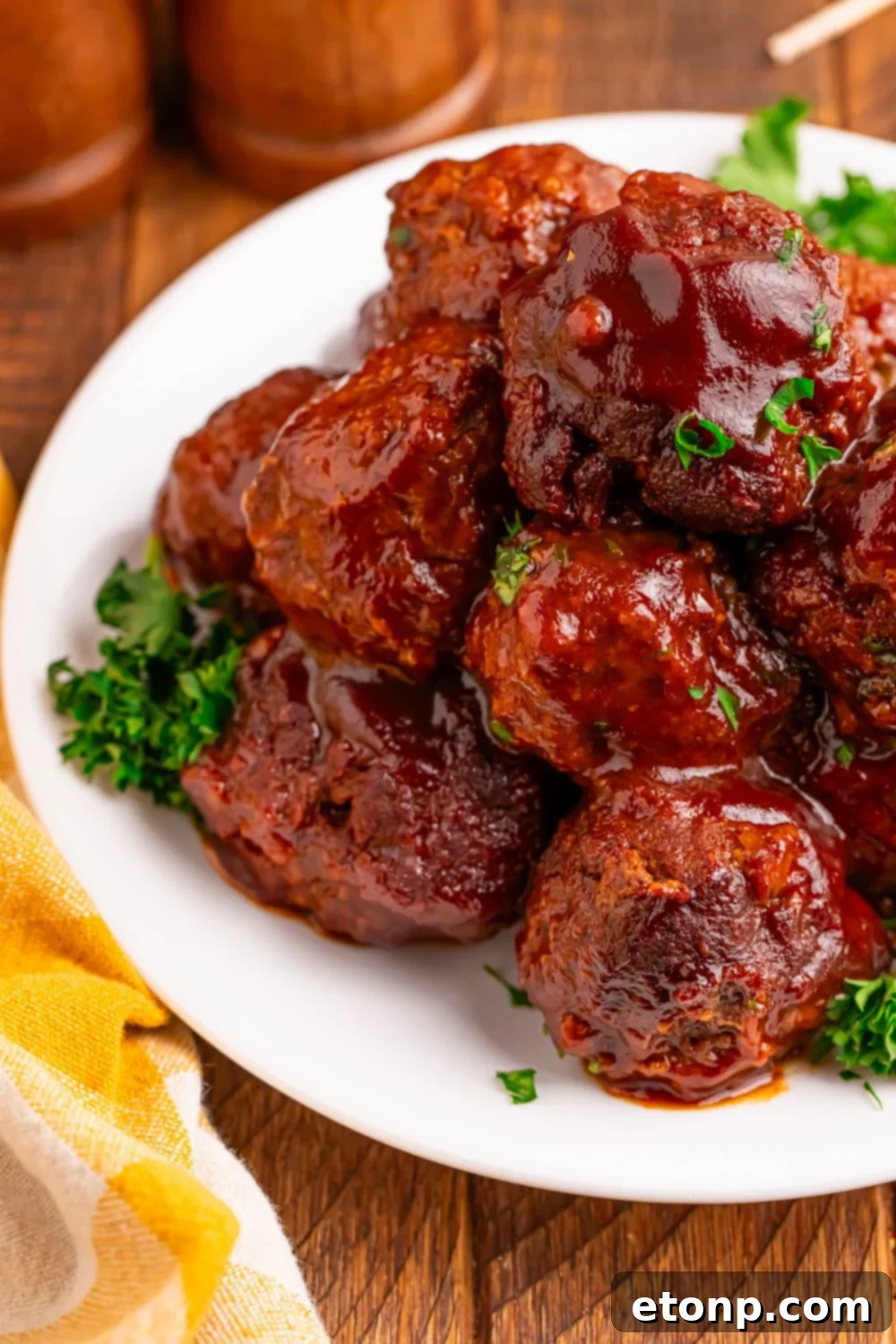 Slow-Cooker BBQ Meatball Magic 3 Crockpot Homemade BBQ Meatballs on a plate, garnished with parsley