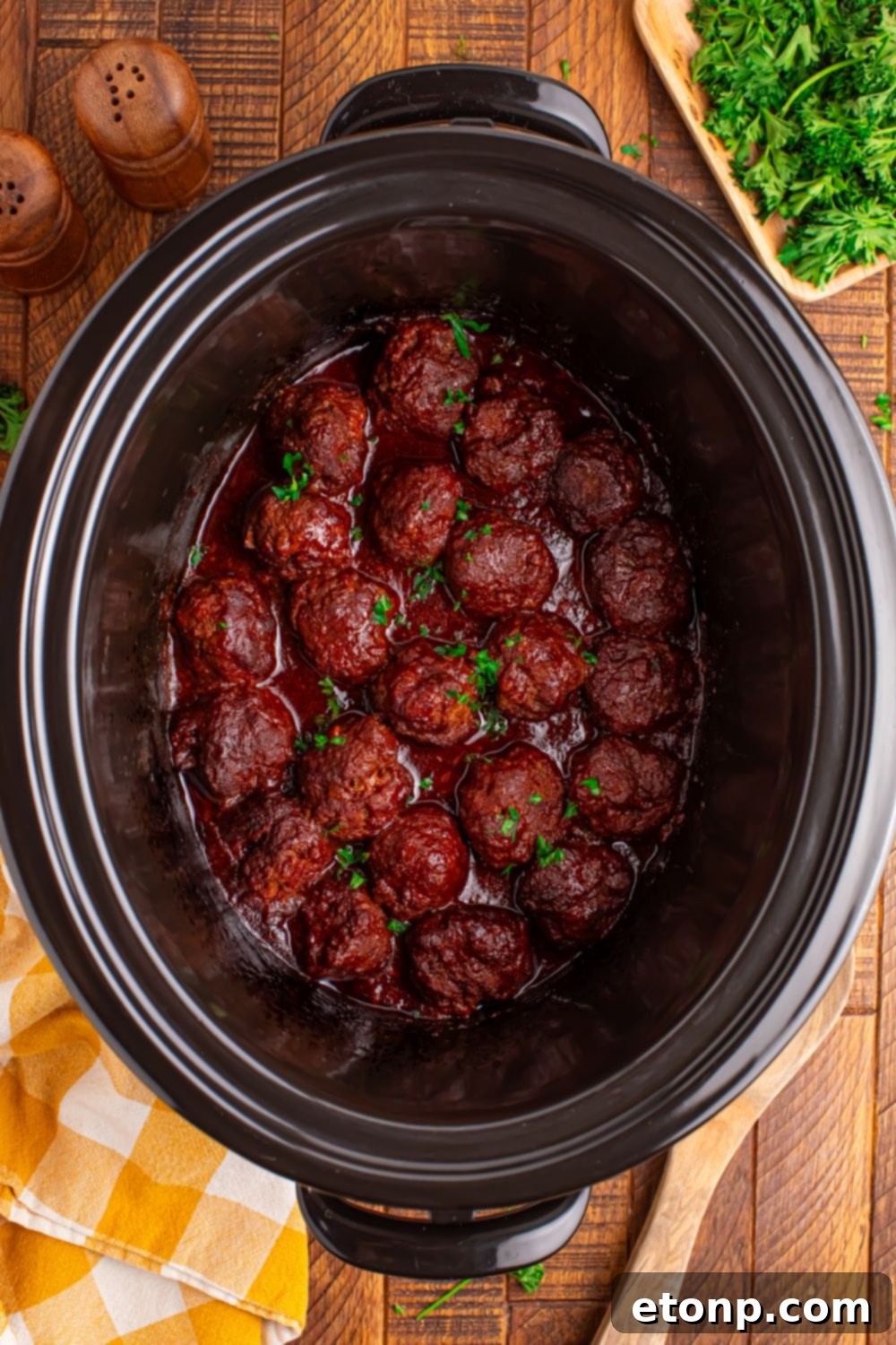 Slow-Cooker BBQ Meatball Magic 6 Crockpot Homemade BBQ Meatballs on a table with serving utensils