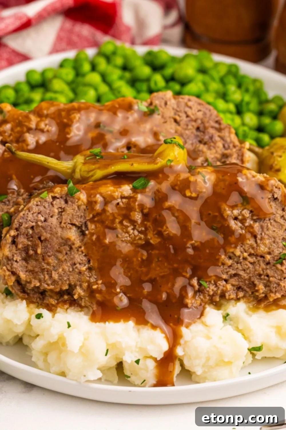 Crockpot Mississippi Meatloaf with mashed potatoes and peas